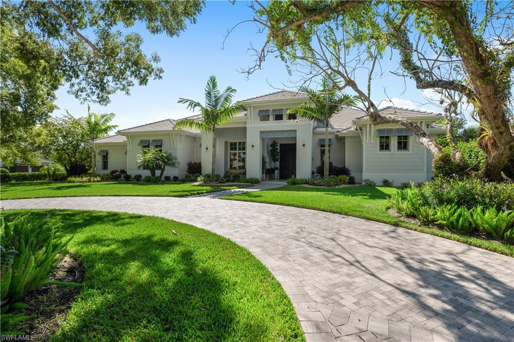 Like new West Indies, Coastal Contemporary custom home with southern exposure is perfectly positioned on oversized corner lot nestled amongst the beautiful Banyan tree-lined streets of Coquina Sands. This fully automated home; all situated on 1 level, with 4 bedrooms plus a study and 6 baths was professionally designed to address the needs of today's discerning buyer.  This light & bright masterpiece with a large great room, grand double island kitchen and spacious, fully-equipped, covered outdoor living area is well suited for indoor-outdoor living and entertaining.  The beautiful circular driveway creates a distinctive, separate, inviting & serene entryway while the large side-entry driveway provides additional utility and parking. With 3 oversized fully finished a/c garages, this beautifully landscaped home is just a short walk to the world-renowned Naples Beaches.