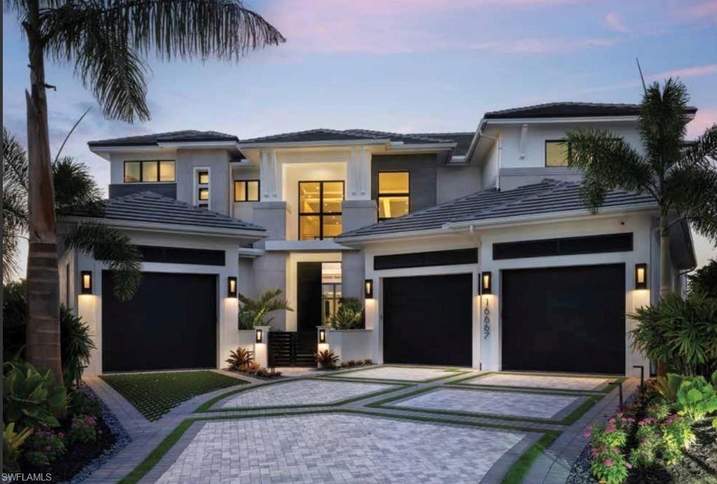 Exceptional lakefront estate in the exclusive Isola Bella enclave of Talis Park, blending innovative design with effortless functionality. This custom-built residence by Seagate Development Group and designed by Theory Design features a spacious open layout with 24-foot soaring ceilings, designer finishes, and seamless indoor–outdoor living. Winner of three San Dollar Awards and was featured on the cover of Home and Design Magazine. Refined composition in the kitchen includes dual Calcutta Marble islands, custom greige tone cabinetry with brushed nickel hardware and amber-hued glass-font cabinets. Gaggenau premium appliances and full-size side by side Sub-Zero fridge and freezer. Large walk-in pantry with two laundry rooms. The great room and dining area open to an expansive outdoor living space with a covered lanai, summer kitchen, dual fireplaces and resort style infinity edge pool and spa overlooking the panoramic water and golf course views. The primary suite provides a private retreat with a sitting area, large walk-in custom closet, and a spa inspired bath with separate vanities, a soaking tub, and a walk-in shower. Additional guest suites offer comfort and privacy, and the home includes a dedicated office/den and spacious three car climate-controlled garages and whole home generator. Located within one of Naples’ premier luxury gated communities, residents enjoy access to a championship golf course, clubhouse, dining venues, fitness center, spa, tennis, bocce, and a resort style pool. Talis Park offers a vibrant lifestyle just minutes from Gulf beaches, shopping, and dining.