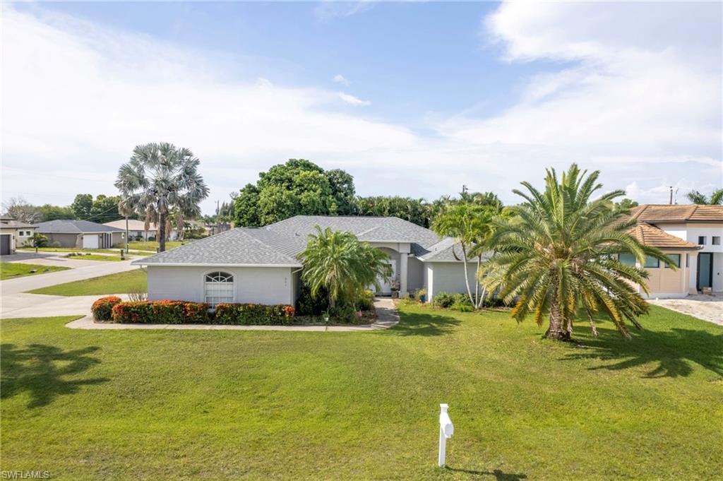 We are delighted to present a remarkable opportunity in the highly desirable area of SE Cape Coral. This stunning Baywood home has 4-bedrooms, 2-bathrooms, featuring a 3-car side-loaded garage on a corner lot is a true gem that combines luxury, comfort, and convenience. Upon entering through the double doors, you walk into a formal living and dining room adorned with elegant tile flooring. The large kitchen offers ample counter space and overlooks a spacious family room with vaulted ceilings, creating an open and inviting atmosphere. A casual dining area and breakfast bar provide additional options for meals and entertaining. A guest/pool bath adds to the home's functionality.
All four generously sized bedrooms feature walk-in closets, ensuring plenty of storage. The master suite is a retreat, boasting a soaking tub, walk-in shower, double sink, and his and her closets. Three sets of sliding glass doors lead to a newly screened lanai, where you can enjoy the heated pool and spa—perfect for relaxation and gatherings.
This home sits on a corner lot with mature landscaping, offering privacy and curb appeal. Additional features include a brand new roof, a new pool heater, and a pool installed in 2006, with AC updated in 2015. The 780 sq ft 3-car garage provides ample space for vehicles and storage. Importantly, assessments are paid, and no flood insurance is required, providing peace of mind.
Conveniently located near restaurants, shopping, parks, and just a short drive to Fort Myers, this home offers the best of Southwest Florida living. Don't miss this exceptional opportunity to own a piece of paradise.