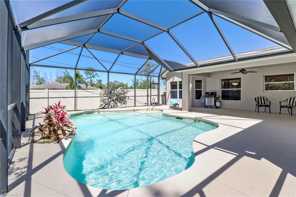 4 Bedroom POOL HOME with a resort style pool and tranquil waterfall! Built in 2004 by Mercedes builder with superb quality & impressively maintained; this home is in pristine condition. All major systems updated- New roof & AC in 2017, fresh exterior paint, fenced back yard and a new under sink reverse osmosis for drinking water. The custom pool was added in 2010, equipped with a solar heater (saves massive $$ on the electric bill) and an extended screened in lanai with super screen. Privacy fencing on either side and the neighbor homes perfectly staggered helps create a backyard oasis. The lot extends well beyond the fenced area for approximately 400 feet with several paths cleared for walking and ample room to add a future outbuilding. Vehicle access to the backyard could easily be created with a relocation of the AC condenser to the back of the home. With over an acre of land and NO HOA this home has the best combination of privacy and space! Located on a dead-end street just minutes to Publix and the new 100 acre Big Corkscrew Island park; currently under construction opening in less than a year. PRICED TO SELL QUICKLY. Matterport virtual tour available & showings permitted.