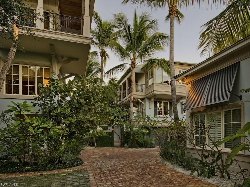 H.7995 - Designed with functionality as well as beauty this luxury home is not only sophisticated but truly elegant offering a perfect balance between formality and livability. Thoughtfully designed by Jeff Harrell in the style of a Caribbean plantation this home presents a clean breezy tropical Florida look with enriched interiors that feature wide-plank black walnut floors and white millwork throughout. This luxury compound offers five bedroom suites plus retreat / study where interior and exterior rooms seamlessly flow that create a resort like atmosphere. Idealistically situated on Champney Bay with serene views of the beyond estuary the lushly landscaped grounds with a mature tropical ambiance create a perfect balance with nature. This property also qualifies for a full Port Royal Club membership.