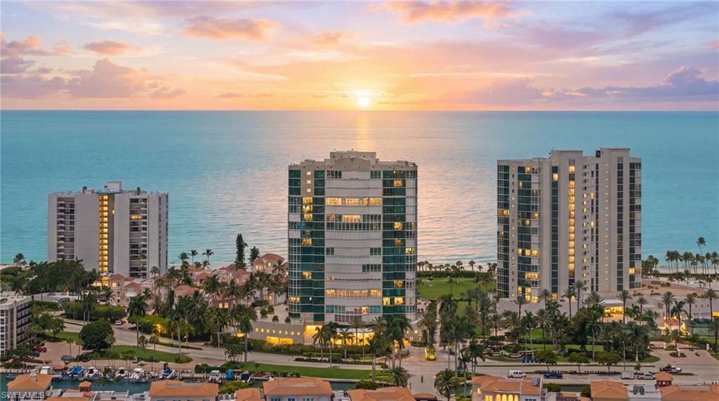 One or more photo(s) has been virtually staged, AI generated or rendered.  Immaculately maintained and exceptionally clean, this residence offers rare panoramic views spanning from east to west, with sunrises over Doctors Bay and spectacular sunsets across the Gulf. Floor-to-ceiling impact glass windows and doors fill the home with natural light while showcasing the expansive water views. Le Ciel Venetian Tower is one of Park Shore's premier beachfront buildings, known for its outstanding management, recent renovations, and comparatively low fees for a property offering this level of luxury, service, maintenance, and amenities. Residents enjoy gated entry, doorman service, 24-hour security, resident manager, guest suites, tennis and excellent beachfront amenities. Venetian Village's waterfront dining, shopping, and entertainment are just a short walk away, while downtown Naples is only minutes from your doorstep. A rare opportunity to enjoy sunrise-to-sunset views in a meticulously maintained beachfront building with exceptional management and one of Park Shore's most desirable locations.