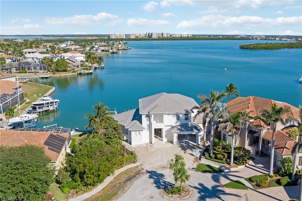 Today's luxury homebuyers want something that is truly special; a place where they can get lost and escape. Upon completion, this estate will be one of Collier Bay's statement properties. This custom Tom Christian-built home is located on a tip-lot in the desirable Tigertail Beach area with 162’ of direct access frontage on Collier Bay and offers expansive views from nearly every room. The four-bedroom, five full and two-half-bath residence with two dens/office spans over 4,500 air-conditioned square feet with an open great-room style plan. Amenities include an elevator, smart house technology, walk-in pantry with full-height wine fridge, oversized two-car garage and more. The home was designed with today's style in mind, incorporating beautiful wood/earth tones and boasts incredible craftsmanship, quality and finishes throughout. The open lanai offers a beautiful backdrop of the picturesque views of the bay, spacious pool/spa, sun deck and stacked-stone fireplace. Nice docking facility with built-in slip, 16k-lb lift and additional 4.5k-lb platform lift, ideal for wave runners. This location offers quick, easy access to the Gulf of Mexico; adventure right from your backyard.