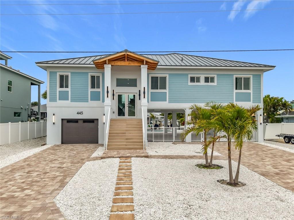 Luxury NEW CONSTRUCTION home offering elevated coastal living in this spectacular Florida Beach Vernacular masterpiece, showcasing 80 feet of pristine water frontage. Designed for refined beach-island living, this residence seamlessly blends modern sophistication with relaxed coastal elegance.
The thoughtfully designed interior features three spacious bedrooms and two beautifully appointed bathrooms, complemented by an open-concept living area that maximizes natural light and captures serene water views throughout, generator ready with transfer switch installed.
At the heart of the home, the gourmet chef’s kitchen impresses with top-of-the-line appliances, custom cabinetry, and an elegant built-in wine bar, creating the perfect setting for entertaining and everyday luxury.
Seamless indoor-outdoor living enhances the coastal lifestyle, with ample space to relax, entertain, and enjoy  waterfront surroundings. Ideally located near Fort Myers Beach, this exceptional property offers convenient access to white-sand beaches, boating, dining, and entertainment.
Step outside to an expansive balcony, a natural extension of the living space, offering breathtaking Intracoastal views and unforgettable sunsets.--perfect for enjoying time with family or friends. Outdoor living continues with a covered patio, perfect for lounging, dining, and hosting gatherings, and a resort-style backyard featuring a sparkling pool, tiki hut, and expansive deck overlooking the water.
A true boater’s paradise, the property includes a private lift with direct bay access, no fixed bridges, and unobstructed routes to the Gulf. Built to the latest construction standards, it features hurricane-impact windows and doors and is elevated above current flood requirements, providing safety and peace of mind.
Additional highlights include an oversized one-car garage with ample storage and a climate-controlled bonus room ideal for flexible use or extra storage., **Do not miss it**