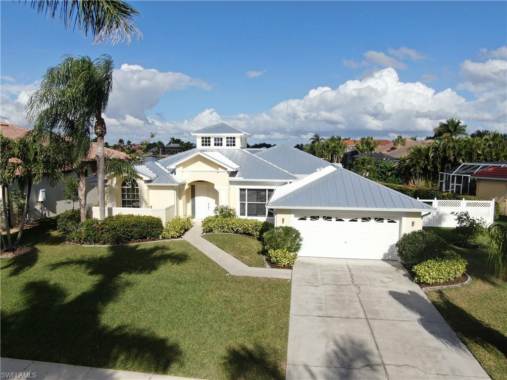 Welcome to VILLA SEA BREEZE, Set Sail today & explore this Custom Key West Style Home located in "THE ROSE GARDEN". Situated on an Over-Sized Lot, this Beautiful Gulf Access Home will absolutely take your breath away. From its Stylish Key's Inspired Architecture, complete with Soaring Cupola, Large Covered Screened Lanai, & "Brand New" Standing Seam Metal Roof, it truly is a Tropical Paradise. Experience "Changes in Latitude, Changes in Attitude" immediately as you enter through the Front Doors, Natural Light floods in from above, Sliding Glass Doors open to an Amazing view looking down the Basin. Home boast 2157 sq ft of Living Space, 3BR, 3BA with Soaring Ceilings, Breakfast Nook, Dining Room & Pool Bath. Recent Upgrades include New Interior & Exterior Paint, Gutters, Tile Floors throughout, Updated Kitchen with New Cabinets, Granite Counters & SS Appliances. Relax in your Heated, Salt Water Pool or lounge on the Large Boat Dock with Plastic Decking & Covered Boat Lift, perfect for Watching Dolphin & Manatee swim by. Boaters will enjoy Quick Access to the River, only 10mins to Tarpon Point. Home is offered "Turnkey" & currently in a Successful Vacation Rental Program, Call today!