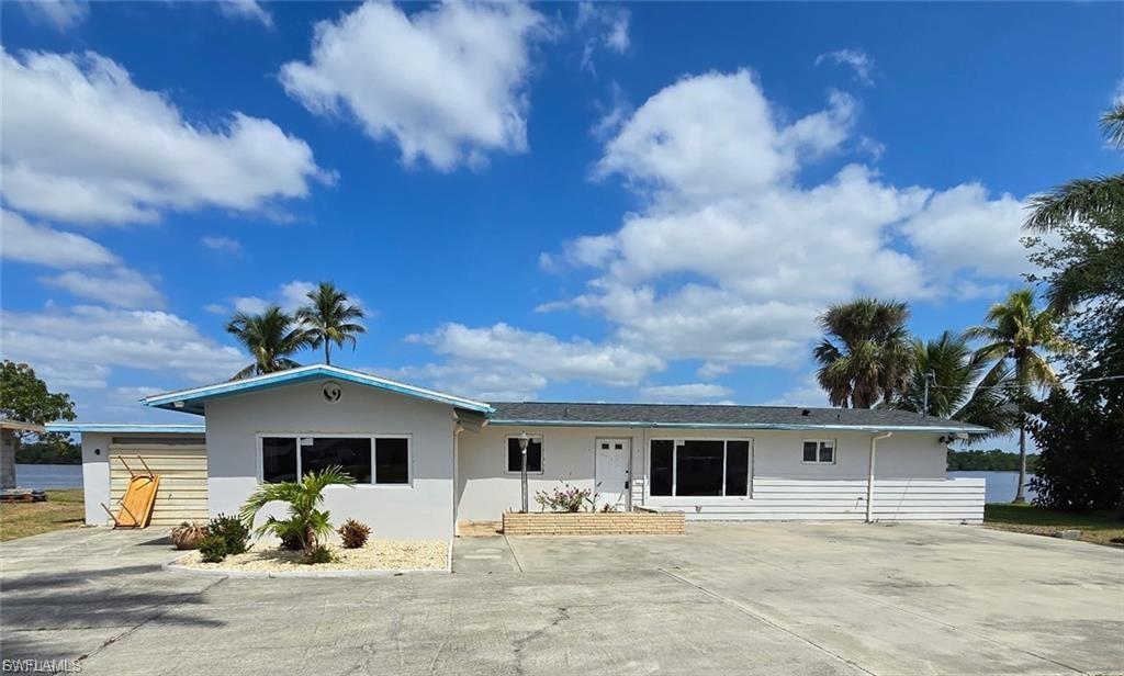Rare riverfront opportunity on the Caloosahatchee River! Situated at 4919 E Riverside Drive, this waterfront property offers breathtaking sunset views, direct boating access, and endless potential to create your dream Florida retreat.

Substantial restoration and renovation work has already been completed, including a new roof, HVAC system, all-new electrical wiring and panel, all-new PEX plumbing, a tankless water heater, impact-resistant windows and doors throughout, and fresh exterior paint. Following storm remediation, approximately four feet of drywall and insulation were professionally removed throughout the home, leaving a clean canvas ready for your custom interior finishes and design vision.

Outdoor features include a private boat ramp, a 40-foot dock, and a 10,000-pound boat lift in good working condition, making this an exceptional opportunity for boating and waterfront enthusiasts. The existing pool remains in place and is ready for cleaning and inspection to bring it back to its full enjoyment potential.

Whether you're looking for a primary residence, seasonal getaway, or investment property, this riverfront gem provides an outstanding foundation in a highly desirable waterfront setting. Bring your imagination and transform this property into a stunning showcase while enjoying spectacular sunsets over the Caloosahatchee River every evening. --More Photos Coming Soon--