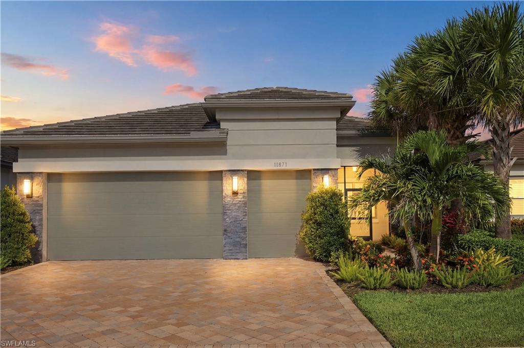 One or more photo(s) has been virtually staged, AI generated or rendered.  Backing to a wooded preserve on a cul-de-sac street, this 2023 Nautilus by GL Homes faces west from the rear, so evenings on the extended screened lanai end with the sun setting over the trees. The single-story great-room plan offers 2,209 square feet under air with three bedrooms plus a den, two full and one half baths, split bedrooms, a coffered ceiling, French doors, glass double entry doors, and a welcoming foyer.

This is a natural gas home, and the kitchen is equipped accordingly: gas cooktop, double wall oven, quartz counters, slow-close custom cabinetry with pull-out drawers and integrated trash and recycle, stainless appliances, an island, and a pantry. Luxury vinyl plank and tile flooring, plantation shutters, LED under- and over-cabinet lighting, and ceiling fans in every room set the finish level, with a Ring doorbell, surround-sound prewire, and a monitored security system in place. The owner's suite looks out to the preserve and includes custom closets, dual sinks, and a frameless glass shower.

The lanai holds a full outdoor kitchen with built-in gas grill, sink, and refrigerator, joined by upgraded 8x8 pavers, backyard lighting, and room to add a private pool overlooking the preserve. Storm protection includes impact-resistant windows and doors, electric remote shutters on the lanai, and manual shutters. The attached 2.5-car garage adds a dedicated golf-cart bay, overhead storage racks, and a utility sink.

Valencia Trails is a guard-gated 55+ community of 838 single-family homes with no CDD. At the roughly 43,000-square-foot clubhouse: a restaurant and bar, a resort pool, lap pool, and hot tub, a full-service spa and salon, an attended fitness center, and billiards, with pickleball, tennis, bocce, a dog park, and walking and bike trails through the community. The $1,611 quarterly master HOA covers lawn care, irrigation water, and security; with the separate $500 annual dining minimum, recurring costs total $6,944 per year, plus a one-time $5,000 transfer fee. Preserve behind, sunset ahead, and the clubhouse within the gates.
