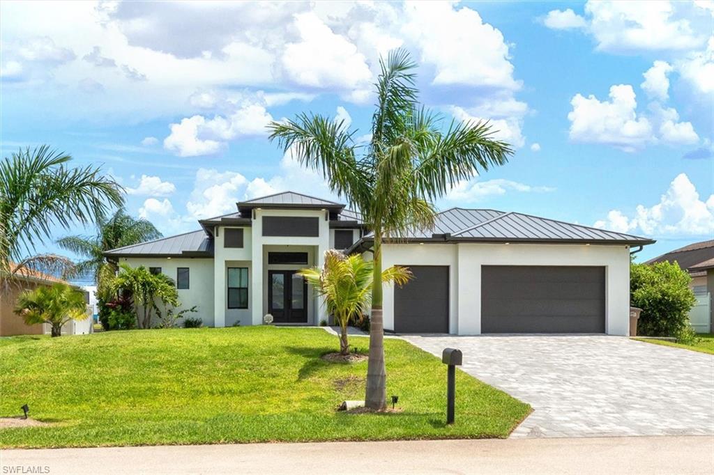 Direct Gulf Sailboat Access home with wide lake views! Built in 2022 to the latest building codes, this immaculate waterfront retreat has never flooded and offers 3 bedrooms, 3 full baths, a den (used as a 4th bedroom), and a 3-car garage. Entertaining is effortless with an open-concept layout that flows seamlessly to the outside via 90-degree/ zero sliders in the great room and additional sliders in the kitchen. The lanai cage is built with extra reinforcement and features picture-window screening on all three sides for unobstructed, panoramic views of the wide spreader canal. Step outside to enjoy the resort-style pool/hot tub (with a Pentair remote system to manage "on/off/heat/etc"), high end pavers, outdoor kitchen, and a private boat dock equipped with a 10,000 LB lift and tiki hut. Sailboat access with seawall takes you directly to the Intracoastal Waterway, and beyond to the Gulf and the Atlantic Ocean.  Inside, the modern custom kitchen takes center stage with a waterfall quartz countertop, premium stainless-steel KitchenAid appliances (including a wall oven and cooktop with overhead vent and icemaker), shaker cabinetry, and a spacious walk-in pantry. Wide-plank tile flooring runs throughout the entire home for warmth and continuity. The luxurious primary suite features dual walk-in closets and a spa-inspired bath complete with a freestanding tub, an ADA-compliant walk-in shower, and a quartz vanity with dual sinks.Live nearly utility-free with 53 roof-mounted solar panels that virtually eliminate electric costs (fixed solar loan of $315/mo plus a $25/mo Utility Co hookup fee). Excess electricity is sold back to the electric co - owner gets an annual check!  Private well water and a septic system mean absolutely no water or sewer bills. Furniture and washer/dryer are negotiable, making this a true turnkey opportunity! Completed Premium Upgrades:Hurricane-impact windows and doors; Brand-new metal roof (Aug 2025) with transferrable warranty & new gutters; Newly reinforced pool cage with picture-window screening; Whole-house reverse osmosis water system; Tankless on-demand water heater; Open-cell insulated attic for maximum energy efficiency; Electric built-in fireplace in the great room; Integrated security cameras; outdoor kitchen; AC with ultraviolet bacteria killer; RV/car electrical hookup. Homeowners Insurance is $2650 per year and flood insurance is $890 per year!  Builder was Diamond Gulf Construction.