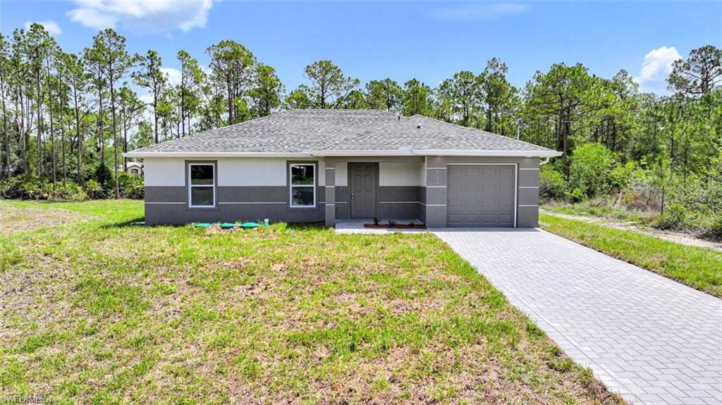Brand-New Construction on an Oversized 0.39-Acre Lot!

Welcome to this beautifully crafted 3-bedroom, 2-bath home located in the desirable Greenbriar area of Lehigh Acres. Situated on a spacious oversized lot surrounded by mature trees, this move-in-ready residence offers the perfect blend of modern design, quality craftsmanship, and peaceful Florida living.

Step inside to an open-concept floor plan featuring soaring ceilings, designer porcelain tile flooring throughout, and abundant natural light. The gourmet kitchen is a standout with quartz countertops, real wood soft-close shaker cabinetry, stainless steel appliances, a stylish glass tile backsplash, a floor-to-ceiling pantry, and a large breakfast bar perfect for entertaining.

The split-bedroom layout provides privacy, while the spacious primary suite includes a walk-in closet and an elegant en-suite bath with quartz countertops and custom tile finishes. Additional highlights include impact-resistant windows and doors, upgraded baseboards, contemporary lighting and ceiling fans, a dedicated indoor laundry room complete with washer and dryer, and an epoxy-coated garage floor.

Outside, enjoy the covered lanai overlooking the expansive backyard with plenty of room for a pool, outdoor entertaining, or simply relaxing in a private, natural setting. The paver driveway, fresh landscaping, well and septic systems, and quality construction complete this exceptional property.

Conveniently located near shopping, dining, golf courses, parks, schools, FGCU, Southwest Florida International Airport, I-75, and the beautiful Gulf Coast beaches, this home offers outstanding value whether you're looking for a primary residence, seasonal retreat, or investment opportunity.