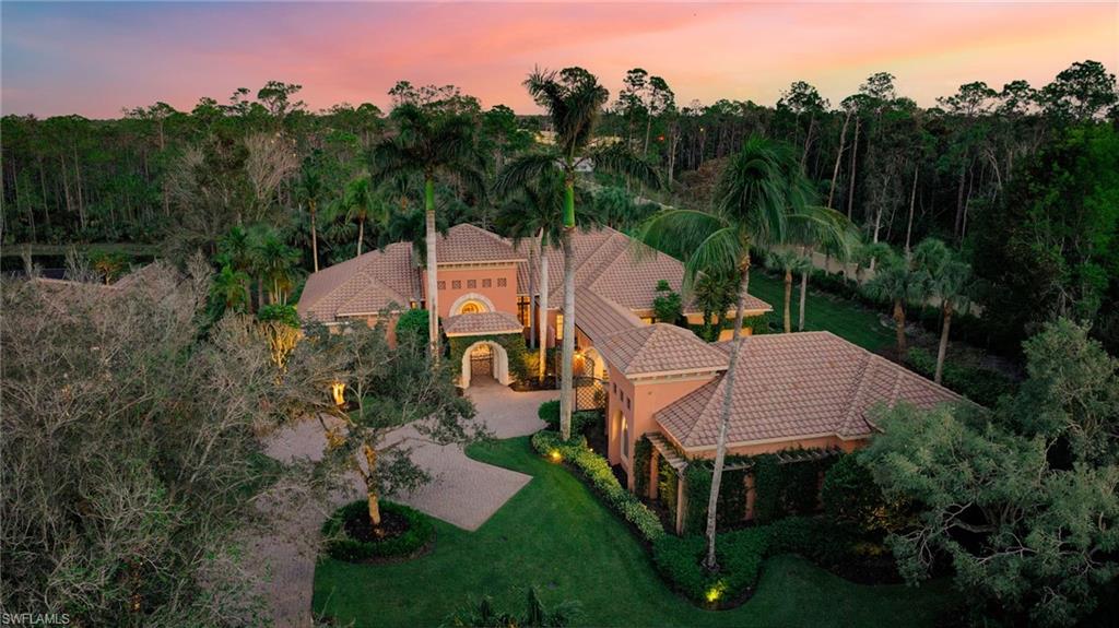 Imagine living in the heart of Naples, Florida, where palm trees sway and the sun shines year-round. Have you ever dreamed of a life within an award-winning, gated golf community, complete with a luxurious private haven? This dream can now be your reality. Located in Southwest Florida's tropical paradise, this stunning luxury pool home offers both elegance and comfort. 
The lush landscaping and Mediterranean-inspired architecture welcome you into a serene outdoor space. Relax on the expansive wrap-around lanai with an outdoor gas fireplace, equipped with automatic roll-down screens, and enjoy the peaceful sound of the waterfall flowing into the beautiful pool. This home also features several courtyards and an outdoor shower in the master bath.
Inside, every detail reflects modern luxury and timeless craftsmanship. Intricate woodwork, intelligent lighting, and rich hickory wood floors create an inviting atmosphere. The gourmet kitchen is a chef’s dream, with quartzite countertops, a gas stove, and premium finishes. Whether hosting guests or enjoying family time, this home offers seamless flow and ideal spaces for relaxation and entertainment.
Car enthusiasts will love the oversized, air-conditioned garage, complete with a hydraulic lift and room to store up to seven cars. Built by Kurtz Homes, a renowned Southwest Florida luxury builder, this property showcases exceptional quality and thoughtful design.
Situated in Mediterra, an award-winning golf community, this home gives you access to top-tier amenities, including two Tom Fazio-designed championship golf courses, a private beach club, and a state-of-the-art fitness center. Mediterra’s offerings enhance your lifestyle, combining relaxation with recreation.
This exquisite property is more than just a house; it’s an invitation to live the Naples dream. Make this luxurious home your own and enjoy the unparalleled beauty and serenity of Southwest Florida.