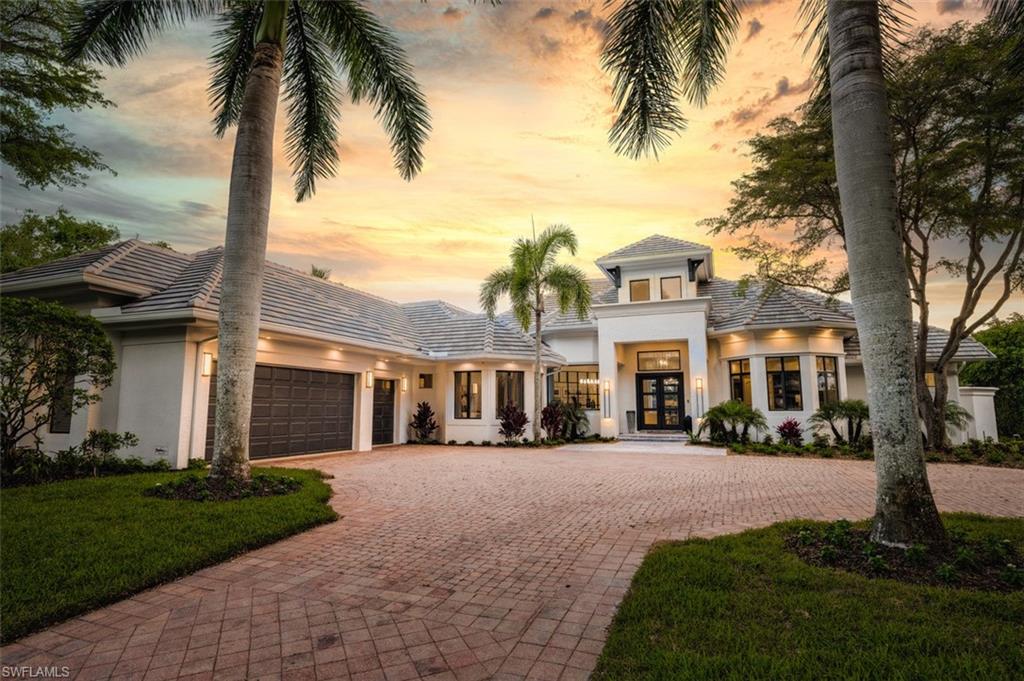 Re-imagined estate home in The Colony Golf & Bay Club.  The successful collaboration of Imperial Homes of Naples and Clive Daniel Home produced a stunning masterpiece capturing six Florida and National awards in 2023.  Located on a waterfront, west facing, private lot this once Old World Mediterranean style home now reflects Modern California Chic.  Comprehensive changes include European white oak floors, reconfigured dividing walls, columns removed, arches squared, dining room showcased with 3 sided glass & metal walls, sophisticated living room has floor to ceiling custom fireplace, lanai and pool transformed with marble flooring, new spa, summer kitchen and entertainment wall with linear fireplace. The award-winning Kitchen with its white and charcoal cabinets, large island, 6 burner commercial range, black Onyx back accent wall and separate coffee bar is a chef’s dream.  Primary suite features opulent bath that gleams with oversized porcelain tiles, freestanding tub and floating vanities. Living at the Colony owners enjoy dining at the waterfront Bay Club, tennis, kayaks, fitness and  private island beach park  accessed by boat shuttle. Golf optional at The Colony Golf Club