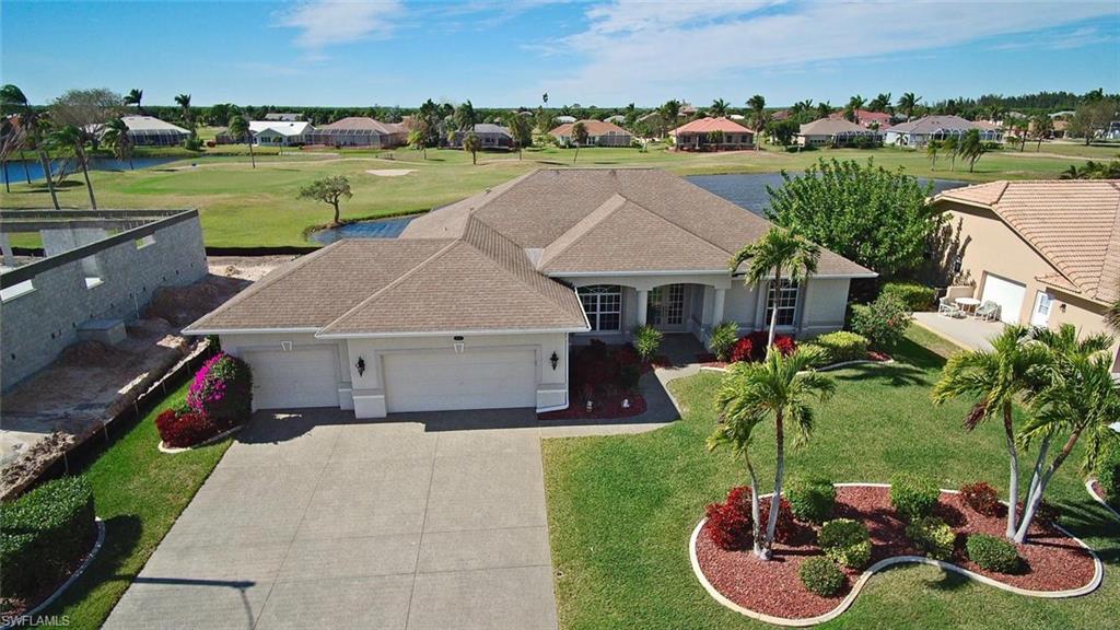 It is located on a quiet cul-de-sac Rd. w/No Thru Traffic yet Close to the Entrance of The Community. A Golf Course Lake behind the Property Buffers you from having Golfers in your Back Yard while affording a Wide Open Spacious View. It offers an Open Design w/High Ceilings thru-out. It is a Open floor plan with a large family room and the kitchen has a snack bar & nice dining area. It sits on an Oversized Lot with 3 Car Garage. Other Features include a Large Shower in Master w/His & Hers Sinks, Corian Counters in Kitchen & Corian vanities in Baths. New Air Conditioner and Hot Water Heater in 2017. New Pool Heater in 2013. Motorized Roll Down Kevlar Shutters on Lanai area, Motorized Metal Roll Down Shutter on the front door, and  accordion shutters on rest of home. Rescreened Pool Cage in 2014. Relax by the pool/spa and enjoy evening sunsets overlooking the golf course. Cape Royal is a gated, financially strong community without all the fees, Pine Island public water and it's location in Lee County(not Cape Coral) means lower taxes and water fees. AFTER LOOKING AT THE PICTURES AND VIRTUAL TOUR, YOU WILL WANT TO LIVE IN THIS HOME!!