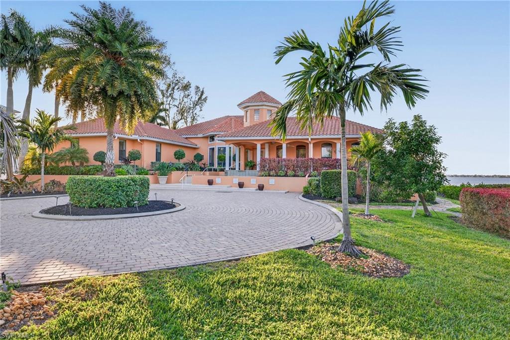 Set behind gates on nearly two acres of prime Caloosahatchee River frontage, 2600 McGregor Blvd delivers a level of privacy, scale, and waterfront access that is increasingly impossible to replicate. With 163 feet of direct river frontage, sunset views stretch endlessly across open water, creating a daily backdrop of natural beauty.

This custom-designed residence offers refined single-story living with four bedrooms, four-and-a-half baths, a private den, and expansive indoor and outdoor entertaining spaces. Grand volume ceilings, impact-rated windows and doors, elegant millwork, and thoughtfully curated architectural details create a sense of timeless sophistication throughout.

The chef’s kitchen anchors the home with generous prep space, a center island, gas cooking, and a seamless flow into the family room, where zero-corner sliders frame the river and blur the line between indoors and out. A butler’s pantry and dedicated wine storage elevate hosting to an art form.

The primary suite is a true sanctuary, featuring panoramic water views, dual custom closets, a spa inspired bath, and a private fitness area.

Outdoors, enjoy a heated pool and spa, covered entertaining areas, and a private dock with two boat lifts providing direct access to Fort Myers Beach, Sanibel, Captiva, and the Gulf. Recently installed Garrison flood panels add peace of mind, while a massive utility garage accommodates up to ten vehicles or prized collections.

Walkable to Edison Ford Estates and just minutes from downtown Fort Myers, this is waterfront living at its most exclusive. Available for immediate occupancy.