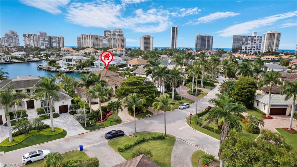 Welcome to 360 Devils Bight in prime Park Shore location - This 4 Bedroom/4.5 Bath with dock is sited on a great south facing lot with stunning Venetian Bay views.  Enter into the welcoming foyer with dramatic ceiling height to an open-concept living area featuring a chef's eat-in kitchen with white shaker cabinetry, white quartz countertops and breakfast bar, stainless steel appliances and walk-in pantry.  Separate wet bar area is ideal for entertaining with refrigerated drawers. Home office with custom built-ins, powder room and convenient laundry room. Walls of glass seamlessly blend the indoor/outdoor lifestyle opening out to screened-in lanai with pool, spa and sun shelf overlooking the bay.  Owner Suite with wall of glass sliders opening out to lanai.  Spacious bathroom with dual sink and separate bath and walk in shower.. Amazing dual walk-in closets.  2 additional guest suites with private bathrooms complete this floor.  Upstairs is the 4th en-suite with a large lanai overlooking the bay.  3-car oversized Air Conditioned garage.  Approximately 85 feet of bay frontage, dock and boat lift.  Easy access to Waterside Shops, Venetian Village and downtown Naples.