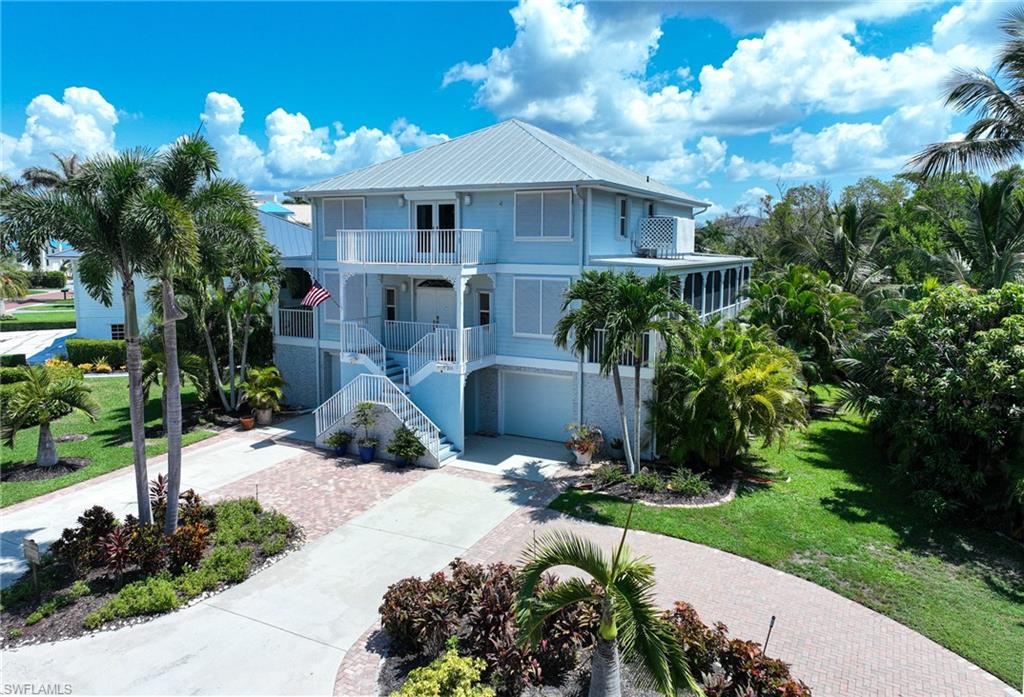 This immaculate 3 story “Florida Beach Style” home is located in the double gated community of Southport on the Bay within beautiful Barefoot Beach and although it is the lowest priced single family home in all of Barefoot Beach it offers everything for the best in Florida beach and boating lifestyle including: over 7,000 Sq Ft of total living area that includes a tropical swimming pool & spa overlooking the landscaped yard, lake with fountain and preserve area for privacy, 3,600 Sq Ft of A/C interior that has been reimagined and completely up-dated with a private elevator to all levels, an open floor plan with fabulous kitchen, large dining and 2 living areas,  4 bedrooms, 4 baths including the ultimate master suite/bath, large covered deck within the screened lanai, walk around porches for easy cleaning and maintenance and two garages with large storage areas left and right (perfect for your kayaks, paddle boards and bikes). Boat docks are available for lease with lifts and no bridges and short distances to the Gulf for premier boating. The beach access is right out the Gate across the street.  Finally, to make your move in smooth and easy this property is being offered turnkey furnished! Barefoot Beach, Collier County’s premier gated beach to bay community, amenities include 24 hour guards and patrols, private beach, brick pavered Royal Palm lined streets and more. Option to join the Club at Barefoot Beach (located in the community - Note: waitlist) which offers casual & fine dining restaurants, pool & beachside food, drinks, chair service, indoor & outdoor bars, ice cream & coffee shop, tennis courts with pro & a full events calendar. Minutes to Mercato, Coconut Point Mall, Promenade & Waterside, the airports and golfing.