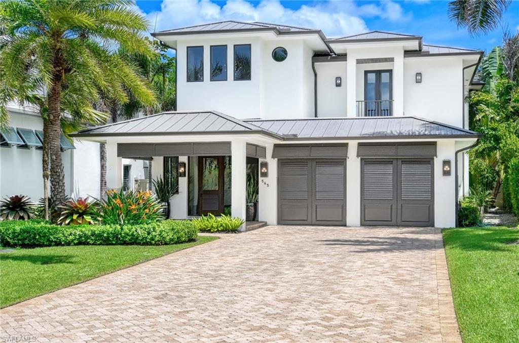 Experience the ultimate Naples lifestyle in this stunning single-family home, ideally positioned on a highly desirable elevated “X500” Flood Zone parcel in the prestigious Moorings neighborhood, just a short walk to the world renowned sugar sand beach. A true value in today’s market, this single-family home offers the benefits of generous living space without the maintenance of an oversized property. Designed with luxury and elegance in mind, every room and every square foot has been thoughtfully planned to maximize comfort and livability. The residence delivers a seamless blend of high-end finishes, functionality, and value, an exceptional find in Naples. Built in 2016 and presenting like newer construction, this 4,084 sq. ft. coastal retreat offers four spacious en-suite bedrooms, a powder room, and a pool bath. The open concept main level is designed for entertaining, featuring European wide-plank white oak flooring, high coffered ceilings, custom lighting and window coverings. At the heart of the home, the gourmet kitchen is appointed with Wolf & Sub-Zero appliances, a gas range, quartz countertops, a waterfall island, Emtek hardware, tiled backsplash, and a dual-temperature Sub-Zero wine cooler. The primary suite is a serene escape with custom walk-in closets and a spa-like bath showcasing teak flooring, double vanities, soaking tub, and a walk-in shower. Upstairs, an enclosed oversized bonus room/loft anchors the space which includes a second large primary suite plus two additional guest suites, each with walk-in closets and private baths. A beverage station and screened terrace overlook the resort-style pool. Seamless indoor-outdoor living defines the backyard oasis with a fire pit, gas heated pool and integrated spa lit by vibrant LED lighting, a covered lounge lanai with a summer kitchen, and pool accessible bath. The fenced yard features landscape lighting that turns evenings magical. As a resident, you’ll have the option to join the Moorings Property Owners Association, granting beach access with exclusive parking, dining pavilion, seating areas, and restrooms. This exceptional property combines contemporary elegance, countless upgrades, and an unmatched location, a perfect opportunity for even the most discerning Naples homebuyer. A must see!