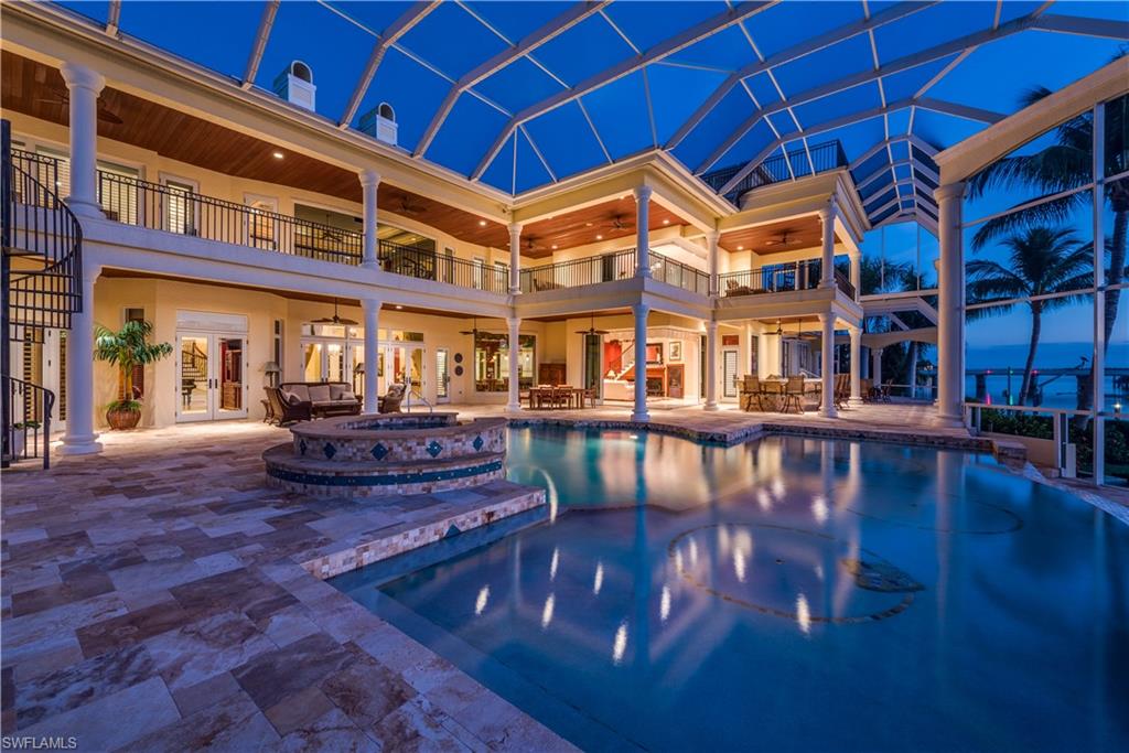 TIMELESS ELEGANCE — Marco Island's Premier Property in Prestigious Estates area! Bring the Yacht, the whole family and all the toys as this Estate home has everything you have been looking for! This stunningly elegant home has 288' on water direct in the southernmost point of Marco Island. 2 docks and lifts with a floating dock complete with resort style pool has a lifestyle you will never forget. Mahogany wood and marble floors, 30' ceilings, winding staircase, 3 story elevator all the way to the rooftop terrace with incredible sunsets every night! Billiards room, fitness room and theatre room all overlooking the beautiful Gulf of Mexico! Gourmet kitchen, 5 bedrooms, 5 baths, his and her incredible dens! Over 8000 SF of lavish interior space with a total of over 11000 SF! Southwest exposure for maximum sun to enjoy the lifestyle Marco Island has to offer!