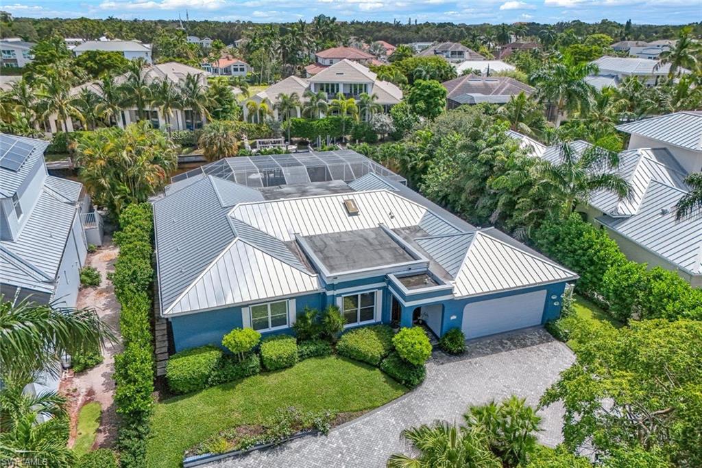 Waterfront Paradise in Seagate, Naples, Florida – The Ultimate Coastal Luxury

Discover Your Dream Waterfront Lifestyle in Naples' prestigious Seagate community! This remarkable 3-bedroom plus den, 3 1/2 bath residence, spanning 3,455 sq. ft., offers the ideal blend of modern luxury and coastal charm in one of Naples' most coveted waterfront neighborhoods.

Elegant Chef's Kitchen: Entertain in style with an exquisite chef’s kitchen showcasing onyx countertops, an oversized island, state-of-the-art appliances, and a designer backsplash that enhances the entire space.

Sophisticated Design: Charming arched doorways, coffered wood-plank ceilings, and bright white wood flooring create an inviting, luxurious ambiance throughout.

Owner's Suite Retreat: The spacious primary suite is a peaceful haven with a cozy sitting area and spa-like bath. Each guest bedroom offers en-suite accommodations, ensuring comfort and privacy for family and guests.

Outdoor Oasis: Enjoy canal views from the sunroom, leading to an exceptional outdoor area with a heated saltwater pool, covered cabana, outdoor kitchen, and shower. The new boat dock and 10,000 lbs lift provide direct Gulf access within minutes! 2021 boat is available for sale separately.

Enhanced Property Resilience: Designed for durability, the property has withstood recent hurricanes with minimal impact, ensuring peace of mind and added value.

Additional Premium Features:

* Metal roof for lasting protection replaced in 2018
* Newly installed paver driveway and lush landscaping with uplighting
* Side yard ideal for pets
* Short golf cart ride to Waterside Shops and Venetian Village for shopping and dining

Optional Seagate Beach Club membership with exclusive amenities, including private beach access, gated parking, and a covered pavilion.
Live the ultimate Naples lifestyle where luxury meets convenience in this exceptional waterfront property – a true coastal sanctuary.