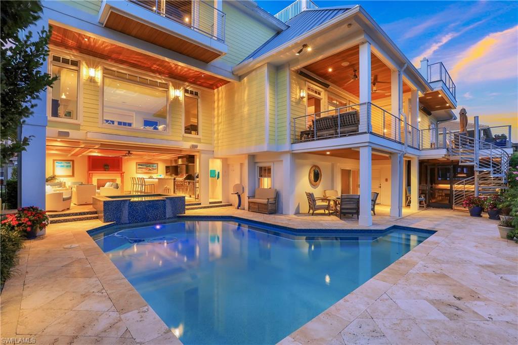 WELCOME TO MARCO ISLAND WITH BIG SMOKEHOUSE BAY SOUTH EAST VIEWS! ! Over 4900SF under air, total of 7900 SF! Impeccable , one of a kind water direct. complete custom renovated home with no expense spared boasts top of the line finishes!  Open Bay Views  from every room and roof top terrace ! 4 bedrooms, one is a bunk room with 6 beds and movie theatre,  7 full baths, one half bath, walnut  loft and maple den! Beautiful walnut flooring through out! 25  foot  volume  bead board  ceilings  in great room  and incredible walnut loft.  Granite gas fireplace in living room  opens to deck and pool area. Gourmet kitchen with gas stove , beautiful glass back splash. top of the line appliances,  breakfast bar and eat in kitchen .  Incredible dining room with beautiful wood ceilings and wet bar. Upstairs Master  has breathtaking  Smokehouse bay views with walk out terrace, volume wood ceilings, huge master bath boasting marble flooring and granite counters, huge closets. Complete family home with game room, extra kitchen downstairs, billiards room and outside bar.. HUGE pool area with  oversized pool and spa, outdoor kitchen, with gas fireplace!  Complete with boat dock and lift!
