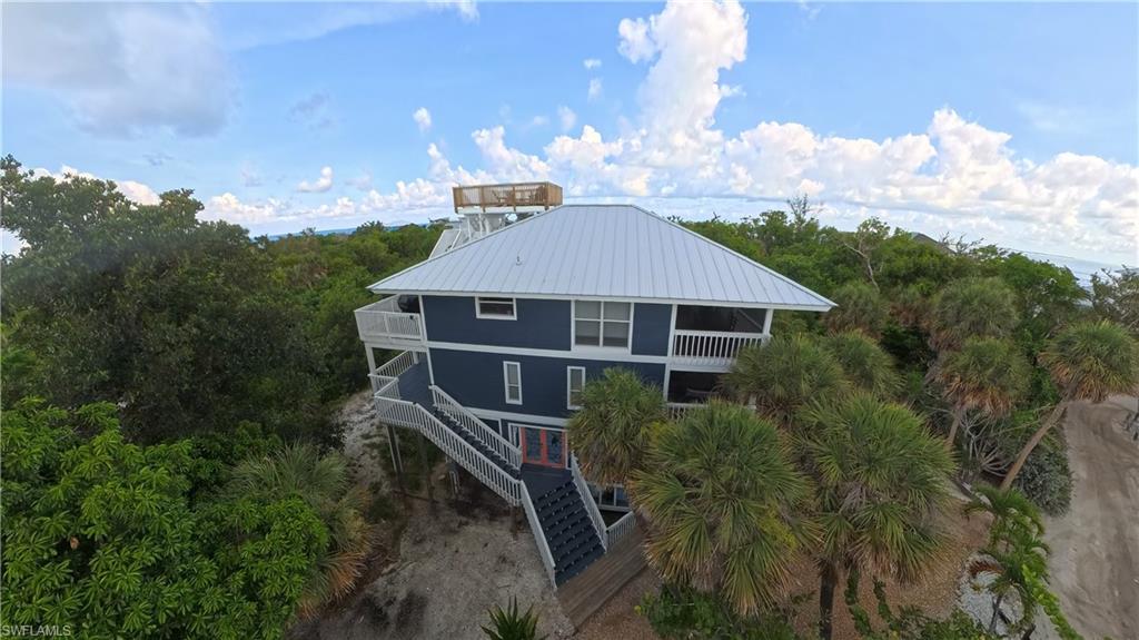 Exceptional opportunity to own a beautifully renovated 5-bedroom, 3.5-bath island retreat just a short walk from the pristine Gulf beaches of North Captiva Island. Offering 1,682 square feet of living space, this coastal home combines modern updates with the relaxed island lifestyle that makes North Captiva one of Southwest Florida's most unique destinations. Accessible only by boat or private aircraft, North Captiva offers miles of uncrowded beaches, world-class fishing, breathtaking sunsets, and a peaceful atmosphere free from cars and traffic.

Thoughtfully designed to accommodate large families and guests, the home offers plenty of space to spread out across multiple living areas and outdoor gathering spaces. The main level features a king primary suite with private ensuite bath, a queen guest bedroom, and a custom bunk room with four twin beds. The lower-level in-law suite provides exceptional flexibility with a king bedroom, a bedroom with two twin beds, a second living area, kitchenette with sink and microwave, and a full bath, making it ideal for extended family, guests, or vacation rental accommodations.

Every level of the home features decks and outdoor living areas, including two screened porches with overhead fans for enjoying island breezes year-round. The crow's nest rooftop deck offers stunning 360-degree views of the island, Gulf waters, and unforgettable sunrises and sunsets.

Extensive recent improvements include a new roof, new siding, updated electrical, new water system, new hot water tank, fresh interior and exterior paint, new decking, a newly constructed crow's nest, rescreened porches, updated landscaping and driveway improvements, new poly outdoor furnishings, luxury vinyl plank flooring, tile flooring, and granite countertops in the bathrooms.

Currently operating as a successful vacation rental, this property offers outstanding income-producing potential while also serving as the perfect private island getaway. Two golf carts are included for convenient transportation throughout the island. Whether you're seeking a personal retreat, full-time residence, or established investment property, this exceptional North Captiva home is ready to be enjoyed.