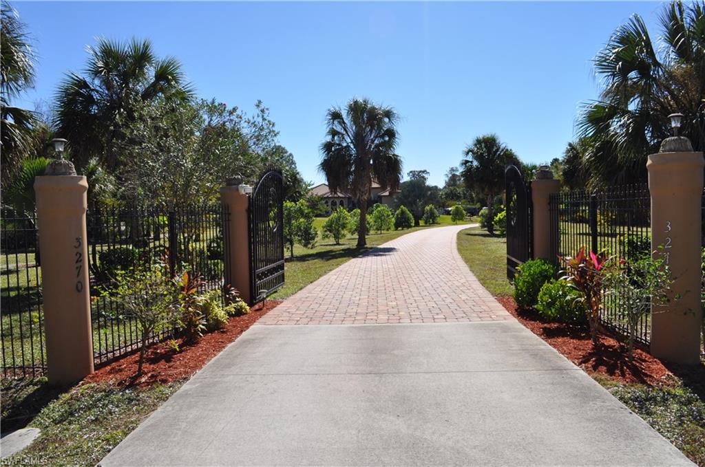 CUSTOM BUILT LUXURY HOME ON PRIVATE 2.27 ESTATE, PRICED TO SELL.  Through the beautiful gated entrance, and fully paved driveway, enjoy this tranquility just 1 mile east of Collier Blvd, yet close to shopping and dining. Perfect home for entertaining, featuring a spacious screened lanai with full cabana bathroom, Bocce court, and over 115 fruit trees & exotic plants!  Just shy of 3000 SF under air, this Mediterranean style home features a formal dining room, spacious living room, open kitchen to family room and breakfast nook, plus small bonus room. Features porcelain tile throughout, tray ceilings, crown modeling, granite, impact windows, and video security surveillance. Entire property cleared and maintained, totally fenced. Large storage shed/workshop with electricity, and extended 3 car garage.  Full house reverse osmosis water system. Well maintained home.
