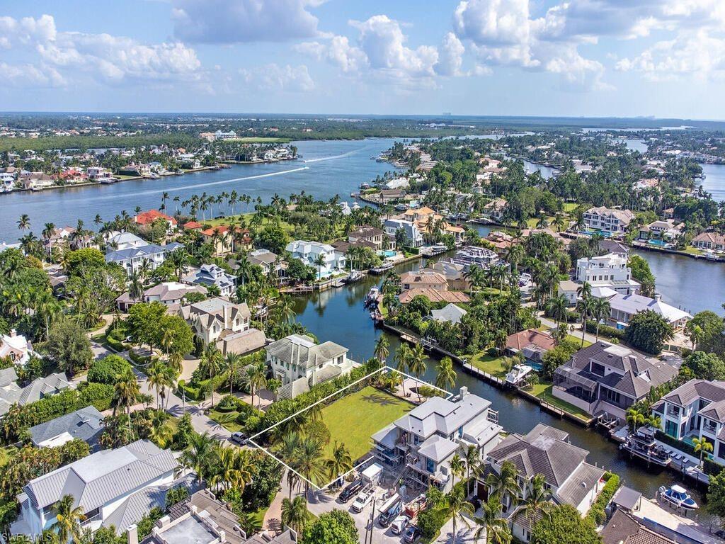 Amidst some of Naples' most exquisite and elegant waterfront homes sits a rare opportunity that offers a home site to design and build your dream home. This property is located on tranquil and dolphin-friendly Kite’s Cove, in highly sought after Aqualane Shores, and has a no bridge access to the Gulf. Southern exposure with approximately 80 feet on the water and a fantastic private, grandfathered in, cut-out dock with two boat lifts. Only a few short blocks to beach access and Third Street South's restaurants and chic shops.