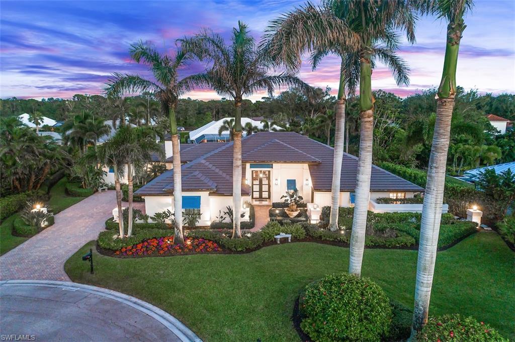 Lush sanctuary in the heart of Pelican Bay Woods. Eight Royal Palms welcomes you to this 4,000-square-foot, single-story residence, offering 4 en suites featuring two masters, 4.5 baths, a private office, open-concept great room with remote control gas fireplace, family room, eat-in kitchen, and 2-car garage with ample built-in storage. Luxurious master suite overlooking pool boasts two walk-in closets, seating area, a stunning soaking tub, dual vanities, and large walk-in shower. Second master features private entrance, terrace, and an oversized bath. Home located on a quiet cul-de-sac on an oversized .46 lot, nestled in lush, professionally designed mature landscaping. True pride of home ownership expertly maintained. New roof, impact windows and doors, security features, and much more. The residence sustained no damage from Hurricane Ian. Ideally located a short distance to Artis Naples, Waterside Shoppes, Publix. Pelican Bay is the hottest location in Naples, offering private access to 3 miles of beach, gulf-side dining, kayaking, sailing, an active tennis program, and more, all surrounded by 88 acres of parks and recreation areas. A must-see for the discerning buyer.