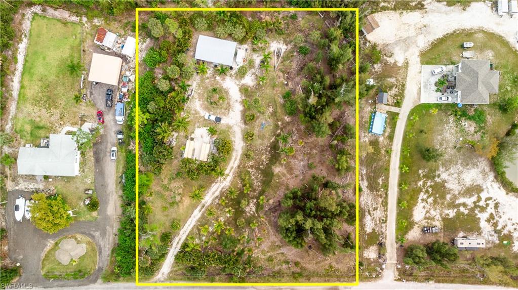 This is the one!! Your very own “Homestead Starter Kit” zoned Ag-2 & cleared and ready for you. Two one acre parcels located in the heart of St. James City on Pine Island, Florida. You will not find another vacant piece of land, especially one that is two acres (not too big, not too small) a very sought after size piece of land because it is the perfect size,  you are able to take care of it comfortably. Whether you dream of moving to Florida to become a palm tree or fruit tree farmer, and then decide you want to build a home with a beautiful lake so you can sit and relax in the evenings this property is set to do just that. Two newer shipping containers sit on the property now, so if a home or manufactured home is what you are wanting to do, both are negotiable to stay on the property as accessory buildings with a home in place. The property already has a barn set on it, and everything that is in it goes with the sale of the property. Many useful tools, and any experienced beekeepers or anyone looking to learn?  Includes all supplies needed to set up bee boxes. For those I mentioned earlier that dream of moving to sunny Southwest Florida to grow palm trees and fruits trees, this property will have no trouble growing with this properties hearty soil. About 20 tri-axles of fill, topsoil, DOT road base all have been dumped and spread throughout the past thirteen years by the current owner. With all of this rich soil, many different species of plants are growing beautifully here. Just to begin, dwarf Malayan coconuts (green and orange), edible banana plant varieties, beautiful sprawling Royal Palms, a mature native to Florida Everglades Fan Palm/ Parotius Palm, lush Areca Palms , perfect for shade this property has beautiful oaks throughout, the gorgeous Seagrape is growing beautifully adding to the greenery. The rare not always seen in landscapes the Moringa tree, used for many medicinal purposes. And to wrap up all of the amazing varieties of plants, mature fruit trees are growing which includes Sapadilla, and many mango varieties.
