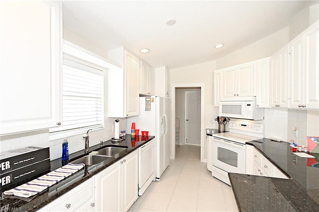 No lake view means more privacy for you! Rarely available, expanded Capri III villa has some pricey upgrades, such as Granite Countertops and a new air conditioner as of this year.  There is a small, open patio in the back to enjoy the park like setting and beautifully maintained grounds.  The floor plan is designed with bedrooms at opposite ends of the home and each bedroom has a full bathroom that forms its own private suite.  The laundry room is bright and spacious with lots of cabinets and storage closet off the oversized garage.  Large living and family rooms are carpeted.  Convenient location to the front entrance of Verona Walk, which has approximately 20 miles of pathways connected by Venetian style pedestrian bridges over beautiful lakes of all sizes.  At the heart of the community is the Town Center, a 20,000 square foot hub of activities to suit many interests.