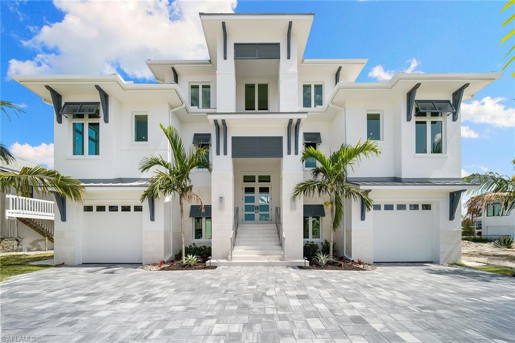 Panoramic bayfront living along Vanderbilt Beach. Positioned along the centerline of Conners Bay, this new construction estate-crafted by Milestone Development with interior selections by Tye Interior Design offers mile-long water views and refined living in one of Naples desirable coastal settings. The residence reflects a balance of timeless design and modern luxury. The main living level features 12-foot ceilings, custom ceiling treatments and wide-plank hardwood floors that frame sweeping views of the bay. A chef's kitchen anchors the space, highlighted by a quartzite waterfall island, professional-grade appliances, and a discreet butler's pantry designed with functionality and elegance in mind. Seamless transitions lead to nearly 500 square feet of covered outdoor living with a summer kitchen, fireplace and unobstructed bay views ideal for year-round alfresco entertaining. The primary suite is a private retreat, complete with a dedicated coffee bar and dual custom wardrobes. A separate study on the main floor offers versatile use as a library, office or media room. The third-floor loft provides an additional gathering area or private lounge for three guest en-suite bedrooms, all opening to a covered balcony with commanding water views. Additional features include a heated saltwater pool and spa, a four-plus-car garage, a recreation room and a newly constructed dock with boat lift. With direct access to the Gulf in just seven minutes by water, this is an exceptional opportunity to own a waterfront lifestyle residence distinguished by superior craftsmanship and design pedigree.