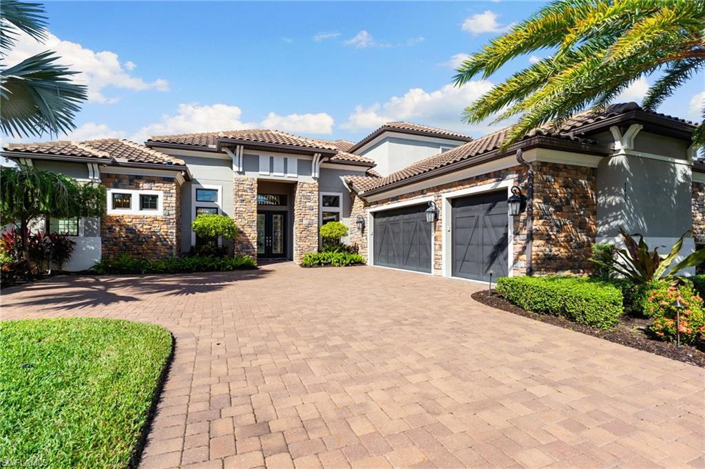 TURNKEY waterfront luxury in exclusive Fiddler’s Creek’s Oyster Harbor. One of the community’s few two-story waterfront residences, this exceptional estate offers nearly 5,000 square feet of refined living designed for comfort, elegance, and effortless entertaining, set within a prestigious private golf club community featuring a newly completed, state-of-the-art golf clubhouse.
Rich architectural details include extensive custom woodworking, vaulted tray ceilings, plantation shutters, and layered accent lighting throughout. Modern upgrades provide peace of mind with a full generator, three HVAC systems, two dehumidifiers, water softener, camera system, whole-home sound system, pool heater with solar assist, Storm Smart hurricane shades, and impact doors and windows. The fully air-conditioned three-car garage features custom cabinetry and a built-in car shop vacuum.
At the heart of the home, the gourmet kitchen is both welcoming and sophisticated, ideal for entertaining, with custom white cabinetry and accent lighting, quartz countertops, two ovens, microwave, 6-burner stovetop, icemaker, and premium Monogram GE Profile appliances. The adjacent dining room showcases a dramatic custom wine stone alcove, while the living room impresses with a stone-clad gas fireplace, custom shelving, and sliding glass doors opening seamlessly to the lanai.
The thoughtfully designed floor plan includes four bedrooms plus a private den, bonus family room, and five-and-a-half baths, complemented by high-end, designer custom furnishings throughout. The owner’s suite offers two walk-in closets, including a custom California Closet, and a spa-like bath with a large walk-in shower. The den features elegant French doors, and the family room opens directly to the lanai and pool area, adjacent to a full bath. Upstairs, guests enjoy a private living space with a bedroom, two full baths, living room, and kitchenette—ideal for extended stays or multi-generational living.
Designed for refined indoor-outdoor living, the home boasts over 2,200 square feet of expansive lanai space overlooking tranquil water views. The resort-style outdoor oasis features a spectacular pool with waterfall, water kettles, spa, natural gas stone fireplace, outdoor kitchen with gas grill, panoramic screen enclosure, travertine decking, and dramatic pool and landscape lighting.
Additional highlights include a tile roof, lush landscaping, and extensive exterior lighting. Residents of Fiddler’s Creek enjoy luxurious resort-style amenities, including a 54,000-square-foot Club & Spa with two onsite restaurants, multiple pools, fitness center, and tennis, pickleball, and bocce courts. Optional golf, beach, and boating memberships enhance the lifestyle. Ideally located just minutes from Marco Island’s pristine beaches and approximately 15 minutes to downtown Naples and 5th Avenue.