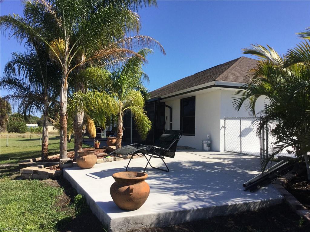 WOW!!! Back on market ! Buyers fell thru!  Seller will contribute up to $5k towards closing costs! Beautiful Home in Lehigh Acres!  on a quiet street close to schools. This Custom built home boasts beautiful tile floors through out the house with an Open floor plan. This house many extras with many upgrades to the landscaping! Nice size Corner property for extra parking in rear and a turn around drive way in the front of home!  Plenty of room to park your toys and plenty of room for a pool! As you walk into this home you will enjoy the slate tile wall accents  that make this house feel like a home not a house. Both Master and Main Bathrooms have been renovated with tasteful finishings. AC unit was replaced in 2018 along with new water filtration system as well and there are new appliances in the home with many upgrades. This large corner lot is fully fenced in the rear that any parent or pet owner would enjoy and there is even a separate concrete padded fenced in dog run on the side of the house. Enjoy the outdoor life while in a screened in patio area that is great for relaxing or entertaining your guests.  Make the move to Paradise! Fall in Love & Make this house your Home!
