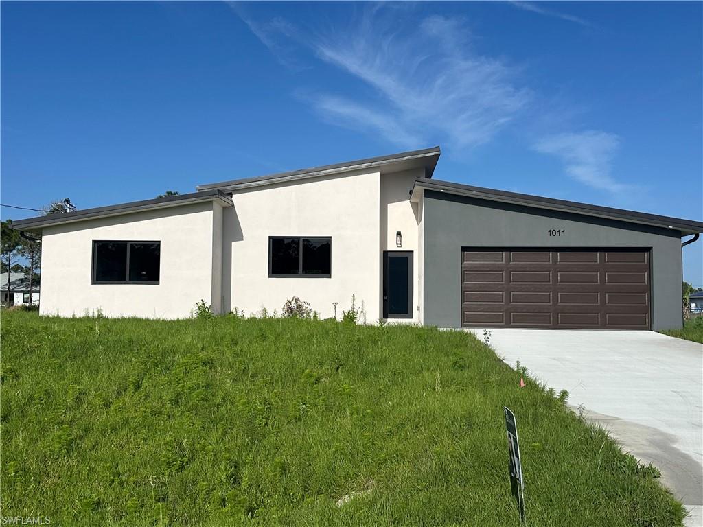 This unique modern house offers luxury at its best. Bright light coming from 18' high ceilings. Built in a half acre lot conveniently located to parks, groceries, banks, main streets., Plenty of acreage to park your RV or boat! Different from other constructions the house is built with metal framing and impact windows and doors. High end kitchen cabinets and countertop. Stainless steel appliances and spacious cabinets for the kitchen lovers. The central space has access to the big and beautiful and complete cleared backyard. Guest bedrooms are arranged on a jack and jill way with customized closets cabinets. Relax on your master bathroom with a warm tub bath. The design intent is to have modern minimal style. Book your tour today.
