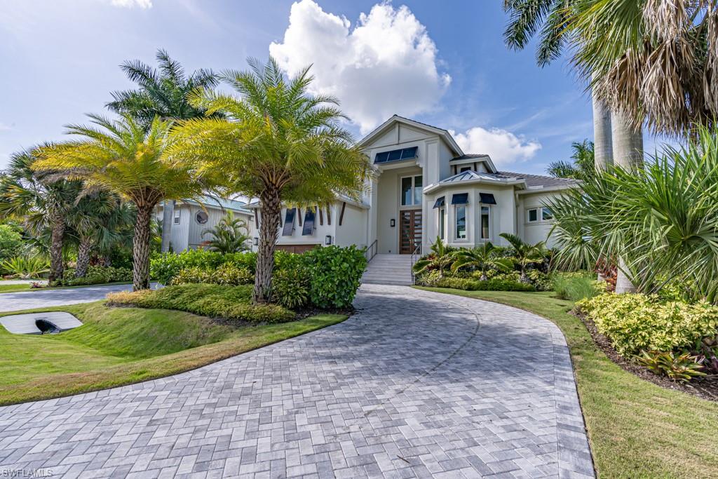 FINALLY AVAILABLE! This gorgeous, southern exposure waterfront estate boasts wide water views of Vanderbilt Bay the moment you walk through the door. Taken down to the shell and masterfully rebuilt in 2018, no expense was spared. Twenty foot entryway ceilings welcome you into this spacious coastal modern open floor plan home, which is perfect for entertaining all year round. Legno Bastone wide plank wood flooring and Ruffino Cabinets throughout are complemented by Wolf appliances that include a Subzero refrigerator and freezer, 48” gas range stove, oven and steam oven. Enjoy expansive bay views from the oversized first floor master suite. The second story of the home features two large en suite bedrooms, one with a walk out balcony also overlooking Vanderbilt Bay. A 500-gallon propane tank powers the tankless water heater, the range and dryer. Expand your entertaining space by opening the 10ft tall sliders to the outdoor deck that has electric lanai screens - perfect for letting the cool bay breeze flow throughout. The entire home features impact windows that look out to the spacious dock, which includes a 16,000lbs boat lift. This slice of paradise is truly any homeowners dream.