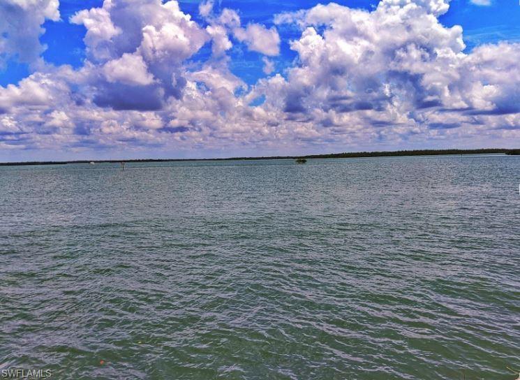 When views and location come together to offer a rarely available homesite on beautiful Marco Island. Enjoy wide water views and the evening lights on the S.S. Jolley Bridge from this premier tip lot with 230 feet of new rip-rap protected and reinforced seawall which affords spacious dock and waterfront deck opportunities. Marvel at the thousands of baitfish attracting larger marine life from the waterfront edge of this half acre lot. Save four months of time in planning and design when you work with one of Marco Island's top design and residential home construction companies with custom floor plans to capture the best panoramic views and maximizing the buildable potential for this direct Gulf access riverfront lot. Imagine your personal residence with 6500 square feet of living area with sunrise and sunset views. From your beautiful new home you catch fish from the private yard, enjoy water skiing or a jet ski, or travel to the 10,000 Islands for a day exploring and fishing. Minutes from the Marco Island Yacht Club and quick access to Collier Boulevard and Naples. Perfect for avid boaters and deep-water access to the Gulf of Mexico.