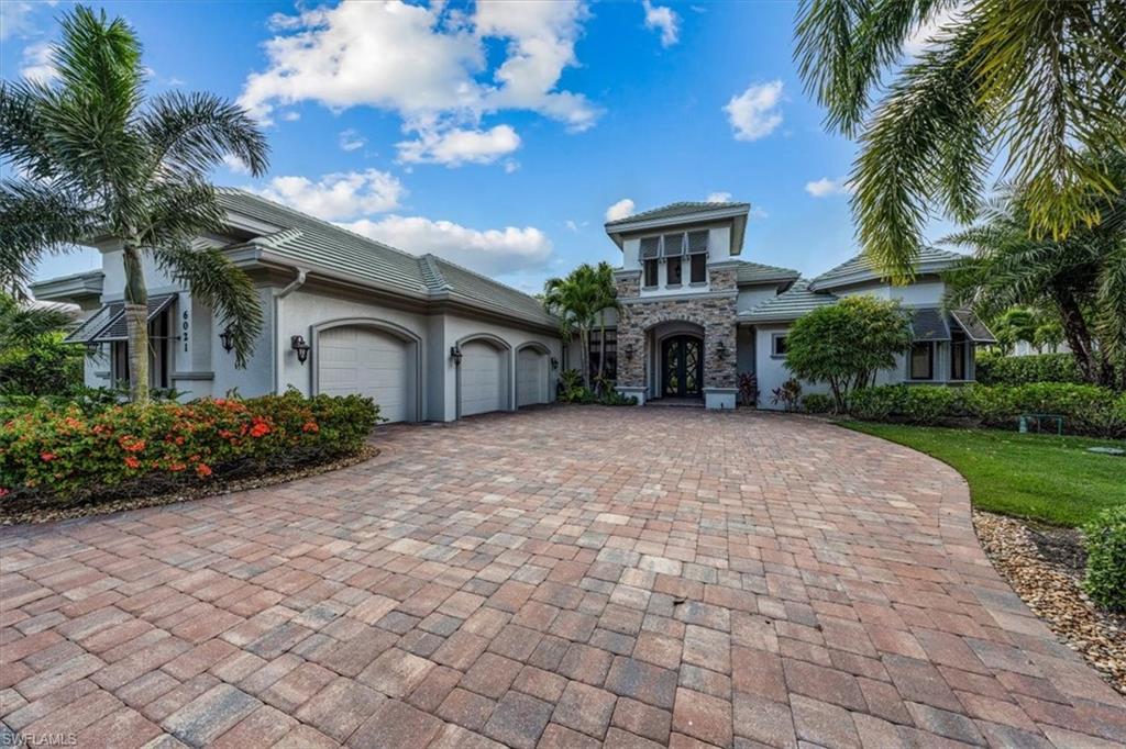 H3849- This sensational home by Florida Lifestyle, perfectly situated on a west facing lot with glorious golf course and sunset views, includes a House membership with assessment fully paid! The grand double door entry and freshly painted exterior welcome you while the striking ceiling effects, chiseled edge stone flooring, custom trim work/crown molding and professionally decorated rooms delight at every turn. The spacious kitchen with double island is the heart of the home and a cook's delight while the master ste provides a relaxing oasis with private french doors opening to the lanai. You’ll appreciate the generous size of the walk-in master closets, lavish soaking tub, large walk-in shower plus double vanity and make-up vanity. Enjoy Florida life from the expansive lanai featuring a heated saltwater pool with grotto/waterfall and integrated spa. The covered outdoor kitchen and bar area plus various outdoor seating areas are enhanced with rich wood ceilings for graceful outdoor
living and entertaining. Additional features include instant hot water system, electrostatic air cleaning system with UV light, Ruffino kitchen cabinetry, upgraded landscape lighting and so much more.