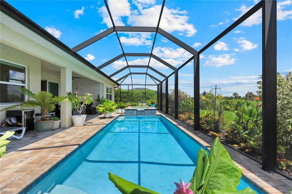 Experience the best of Southwest Florida living in this beautifully designed 2021-built pool home located in the desirable Royal Palm Golf Estates. Situated on an oversized lot with picturesque golf course and lake views, this 4-bedroom, 3-bath residence offers 2,419 sq. ft. of thoughtfully designed living space. The open-concept great room seamlessly connects to a gourmet kitchen featuring quartz countertops, stainless steel appliances, a large center island, pantry, and abundant cabinetry-perfect for everyday living and entertaining. The spacious primary suite offers a walk-in closet and a spa-inspired bath, while the split-bedroom floor plan provides privacy for family and guests. Step outside to your private screened lanai showcasing a heated pool and spa with a solar pool heater, lush tropical landscaping, and an outdoor fireplace, creating the ultimate setting for relaxing or hosting gatherings. Additional highlights include impact-resistant windows and doors, tray ceilings, a 3-car attached garage, tile roof, and low HOA fees. Located in a gated golf community with access to clubhouse amenities, sidewalks, and a public golf course, this exceptional home is just a short drive from Marco Island, downtown Naples, shopping, dining, and Gulf beaches. Luxury, comfort, and Florida lifestyle come together in this move-in-ready home.