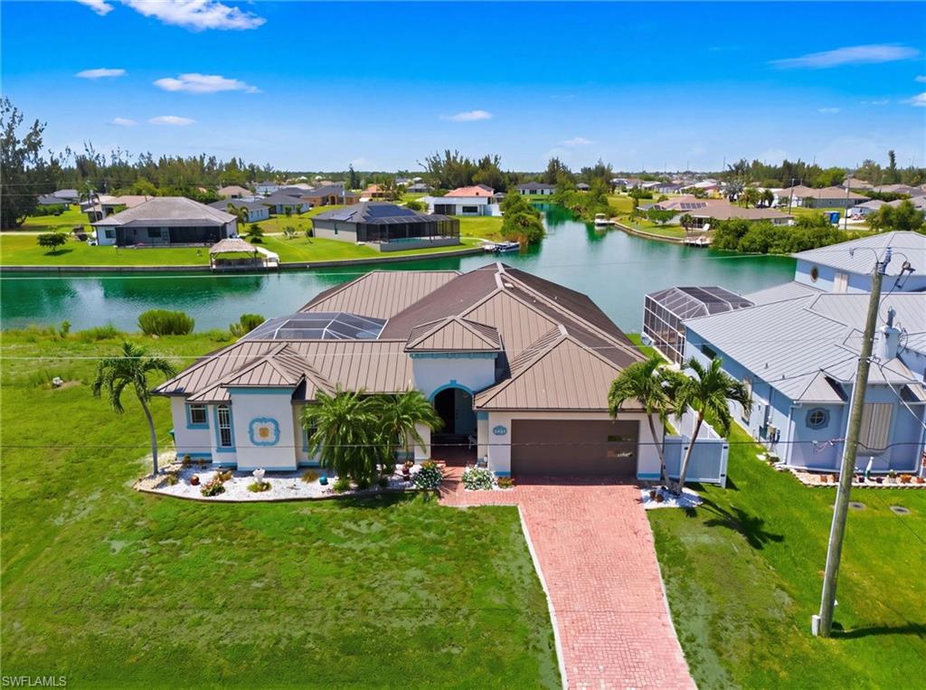 Welcome to one of the area's most unique and rarely available waterfront homes! This exceptional courtyard-style residence offers the perfect blend of privacy, space, and breathtaking waterfront living. Situated on a wide canal with stunning open water views, you'll enjoy unforgettable sunsets, peaceful scenery, and the true Florida lifestyle right from your own backyard. Designed for both everyday living and entertaining, the home centers around a private courtyard featuring a sparkling pool, creating your own secluded outdoor oasis. One of the property's most desirable features is the detached guest quarters/mother-in-law suite a rare find complete with its own private entrance, living room, bedroom, and dedicated pool bath. It's ideal for extended family, guests, a home office, or incredible vacation rental flexibility. Inside, you'll find an expansive, light-filled floor plan with generously sized living spaces and beautiful water views through large windows. The oversized kitchen offers abundant cabinetry and workspace, making it perfect for cooking, entertaining, and gathering with family and friends. Elegant coffered ceilings, crown molding, tile flooring throughout, and quality finishes add timeless style.
The split-bedroom layout provides privacy for everyone. The spacious primary suite features a large walk-in closet and an ensuite bath with dual vanities, a soaking tub, and a separate walk-in shower. Two additional guest bedrooms and a full guest bath are located on the opposite side of the home. An additional air-conditioned flex space near the entry offers endless possibilities for a home office, den, playroom, or hobby room. An indoor laundry room and attached garage add everyday convenience. Step outside to a beautifully fenced backyard with lush green space for pets and play, plus a spacious paved patio perfect for outdoor dining, relaxing, or adding your dream spa. Follow the path to your private dock, where you can fish, launch your next boating adventure, or simply unwind while taking in the spectacular wide-water views, abundant wildlife, and breathtaking sunsets. This move-in-ready home has been thoughtfully updated with a newer metal roof, impact doors, garage door, air-conditioning system, well, and sprinkler system, providing peace of mind for years to come. The attractive paver driveway and impressive curb appeal complete the package. Conveniently located in a beautiful interior neighborhood close to shopping, dining, boating, world-class fishing, Matlacha, Cape Coral, and Fort Myers, this extraordinary waterfront property offers the perfect combination of luxury, functionality, and flexibility. Whether you're searching for your forever home, a multigenerational retreat, or an exceptional investment opportunity, this one-of-a-kind waterfront gem is truly a rare opportunity.