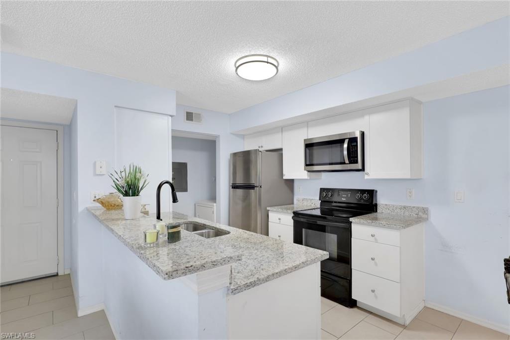 Beautifully updated first-floor condo offering comfort, convenience, and a bright open layout in a well-maintained community. This spacious unit features tile flooring throughout, fresh neutral tones, and an inviting living and dining area filled with natural light.

The kitchen is equipped with granite countertops, white cabinetry, stainless steel appliances, and a breakfast bar that opens seamlessly to the main living space—perfect for entertaining. The generously sized living room flows out to a private screened lanai with peaceful views of lush landscaping and nearby tennis courts, creating the perfect indoor-outdoor living experience.

Whether you’re looking for a primary residence, seasonal getaway, or investment opportunity, this move-in-ready condo is a must-see!