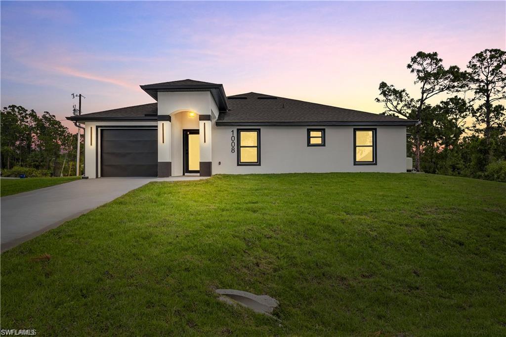 WE welcome you to this stunning and BRAND NEW CONSTRUCTION 3-bedroom, 2 bath corner end unit Duplex in one of Lehigh Acres' most sought after neighborhoods, just a stones throw away from Rt 82 which feeds to Ft Myers, shopping, dining, and major commuter hubs.  With nearly 1,200 square feet of living space, this home offers both comfort and style, perfect for modern living.  This duplex includes a spacious 1-car garage and long driveway, ensuring ample parking and storage space, a large backyard, providing plenty of outdoor space for relaxation and entertainment.  Step inside and the chef in you will be pleased by the beautifully finished kitchen with all the bells and whistles.  Featuring elegant quartz counters, stainless steel appliances, pantry, and contemporary cabinets & lighting, this kitchen is a showstopper! The open-concept living and dining area is flooded with natural light, thanks to the large windows that offer serene views.  This bright and airy space is perfect for entertaining guests or simply unwinding after a long day. The primary bedroom is a true retreat, featuring a quartz vanity and an enlarged closet, providing plenty of storage space. The additional bedrooms are generously sized, each with ample closet space to meet all your storage needs. For added convenience, the unit includes an on site laundry area in the garage with a brand new washer and dryer, making laundry day a breeze. The entire unit is adorned with luxury tile, which not only adds a touch of elegance but also makes cleaning and maintenance easy. The thoughtful design and high-end finishes throughout the home provide a sense of luxury and comfort. Location is key, and this home does not disappoint. Situated just minutes from Rt 82 and Daniels Parkway, you'll have easy access to all the amenities and conveniences you need. Whether you're commuting to work, running errands, or looking for entertainment options, everything is within reach. Don't miss out on this incredible rental opportunity. This gorgeous, move-in-ready duplex has it all – modern updates, spacious living areas, a large backyard, and a prime location.