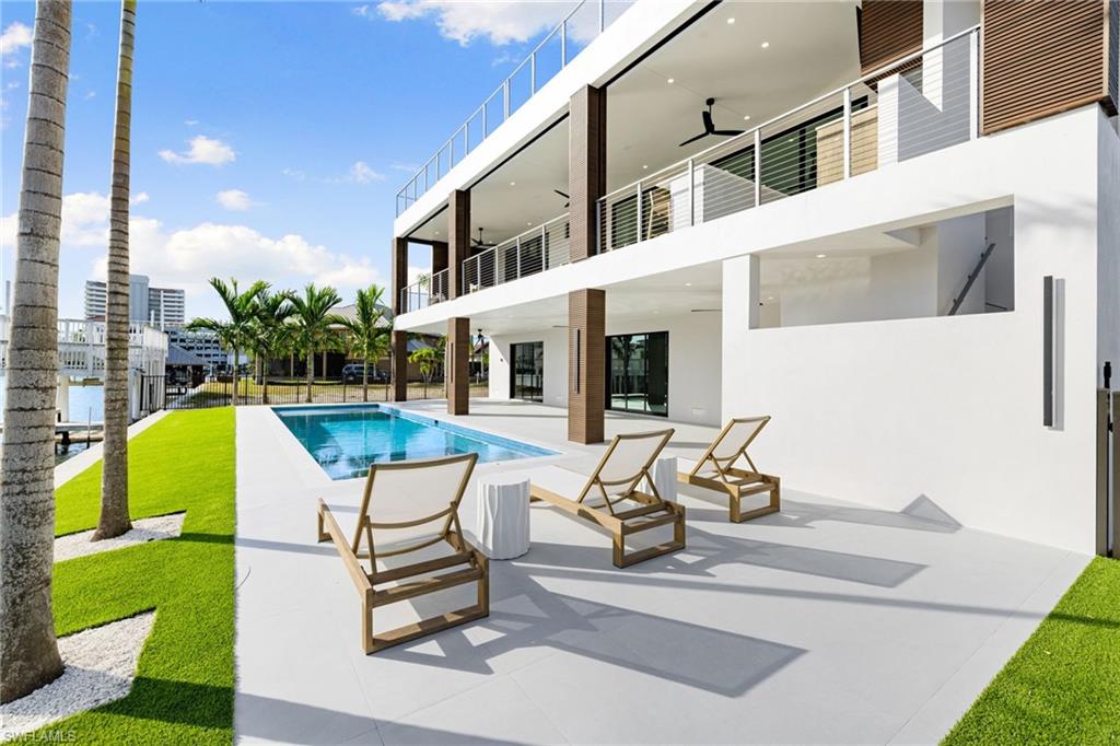 Introducing a NEW and FULLY FURNISHED Gulf-access waterfront residence in one of Naples’ most sought-after coastal communities. Perfectly SOUTH-facing with beautiful bay views and quick Gulf access, this newly constructed luxury home by Fox Premier Builders blends refined craftsmanship with effortless modern coastal living.

Designed for both sophistication and peace of mind, the residence features elevated construction above base flood elevation, impact-rated doors and windows, private elevator, home automation system, whole-house generator prewire, motorized hurricane and bug screens, and a new 80-foot seawall. Expansive outdoor living areas include a saltwater pool and spa, summer kitchen, multiple lounge spaces, and sunset-facing waterfront terraces designed to embrace Naples’ year-round indoor-outdoor lifestyle.

Inside, the open-concept floor plan showcases a chef’s kitchen with custom cabinetry, quartz countertops, Wolf and Sub-Zero appliances, temperature-controlled wine room, and an expansive great room with fireplace and walls of sliding glass opening seamlessly to the outdoor living spaces.

Offering 5 bedrooms and 4.5 baths with refined finishes and designer furnishings throughout, the residence is ideally located just minutes from Vanderbilt Beach, Mercato, the Ritz-Carlton, LaPlaya Beach & Golf Resort, and the highly anticipated Paraiso Beach Club. Combining furnished luxury, modern construction, south-facing exposure, and an exceptional waterfront setting, this home presents a compelling opportunity in today’s Naples luxury market.