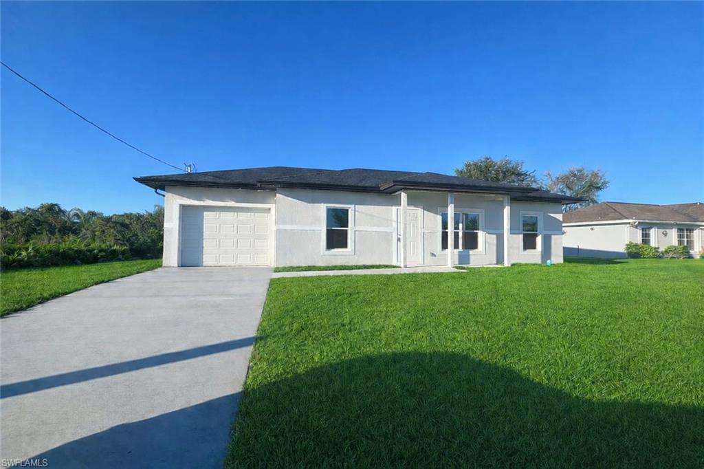 Introducing our NEW CONSTRUCTION - a modern 3 Bed / 2 Bath Home in the heart of Lehigh Acres, FL. This stunning home boasts a sleek design with beautiful tile flooring throughout and an abundance of natural lighting. The kitchen is a chef's dream, complete with granite counters, wood shaker cabinets, and a full suite of stainless steel appliances. The primary bedroom is a true retreat, featuring an en-suite bathroom for added convenience. Two additional spacious bedrooms and a guest bathroom with a tiled shower/tub combo provide ample space for everyone. The home also includes a one-car garage and a washer and dryer hook-up. The exterior is just as impressive with storm protection-impact windows and a covered rear lanai, perfect for enjoying the Florida weather. This brand-new construction is conveniently located close to all amenities in Lehigh Acres. Photos may not be of actual model- for marketing purposes only.