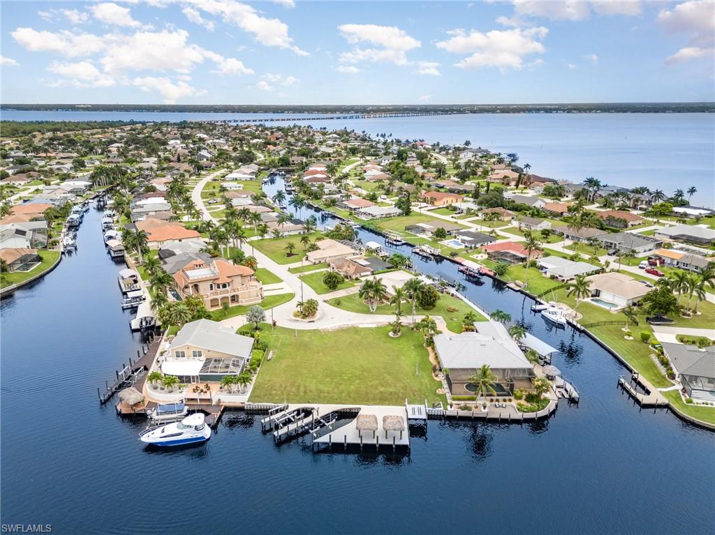 Motivated Sellers — Rare Gold Coast Direct Gulf Access Triple Lot with Major Waterfront Improvements Already in Place
A rare opportunity in Cape Coral’s prestigious Gold Coast, this oversized direct Gulf access triple lot offers the boating lifestyle buyers are looking for — with the expensive waterfront infrastructure already completed. Set on a wide intersecting canal with approximately 135 feet of waterfront, this premier homesite features no bridges, true sailboat access, and a highly desirable Southeast Cape Coral location.
What truly sets this property apart is what is already in place. The sellers have completed a brand-new seawall, and the waterfront is equipped with two brand-new docks, a 30,000-pound boat lift, a 16,000-pound boat lift, a double jet ski or kayak lift, and two tiki huts. Water and electric are already available at the dock, creating an impressive private waterfront setting from day one.
With approximately 0.354 acres of prime land, this triple lot offers the space and presence to design a custom luxury waterfront estate that fully captures the expansive canal views, sunset skies, and exceptional boating access. Public utility assessments are in and paid, adding further value and convenience for the next owner.
Opportunities to secure a direct Gulf access triple lot with no bridges, a new seawall, boat lifts, docks, tiki huts, and approximately 135 feet of waterfront are increasingly limited in Cape Coral’s Gold Coast. The sellers are motivated and ready for the next owner to bring their vision to life in one of Southwest Florida’s most sought-after boating communities.