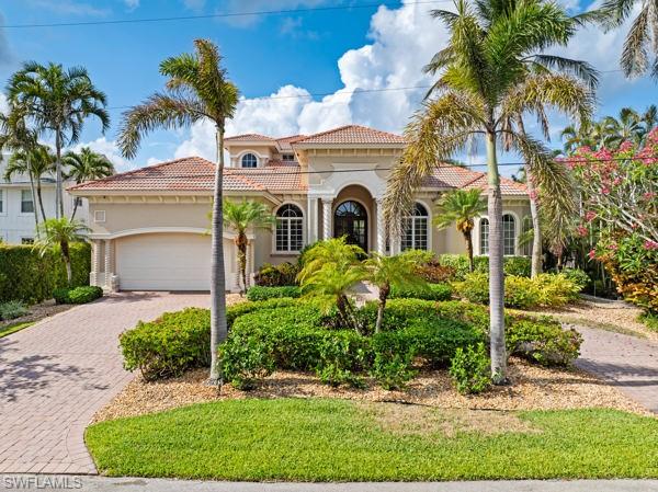 Discover the pinnacle of coastal luxury in this stunning 4 bedroom plus den, 4 bath waterfront home in the heart of
Naples’ Oyster Bay. Spanning nearly 4,161 square feet, this fully furnished property blends comfort, elegance, and direct water access. Designed for both relaxation and entertaining, the main living and family rooms feature neutral décor and abundant natural light, while corner pocket sliders create seamless indoor-outdoor living. Outside, enjoy the resort-style infinity pool with waterfall spa, a covered outdoor kitchen with gas grill, and expansive lounge areas, perfect for year-round gatherings. The gourmet kitchen is a chef’s dream with stainless steel appliances, double wall ovens, wine cooler, island with sink and dishwasher, plus a separate dining nook. A bright dining room seats six with ease. The luxurious primary suite opens directly to the pool area and offers a king bed, walk-in closet, and spa-like bath with dual vanities, soaking tub, and walk-in shower. Upstairs, a third seating area and private balcony capture sweeping southern views of Naples Bay, ideal for sunsets and fireworks. Guest accommodations include three additional bedrooms (king, queen, and twin beds), plus a private bamboo-floored den for work or a quiet retreat. Just minutes from downtown Naples, pristine beaches, and world-class dining and shopping, this home delivers the ultimate in waterfront living.