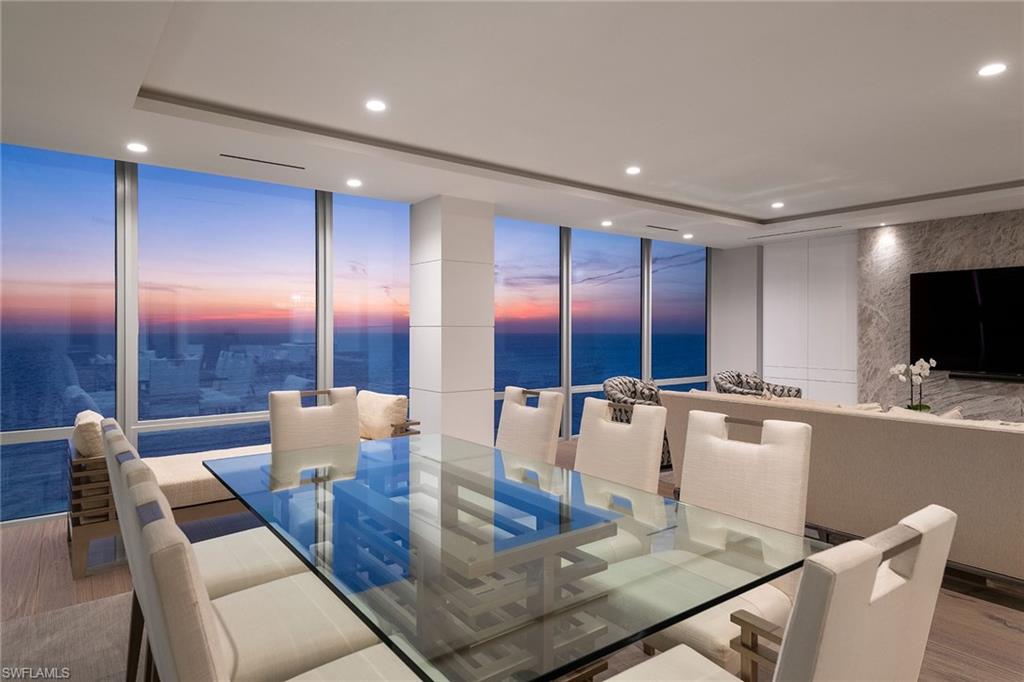 Gulf views & clean lines are the inspiration for this paradise in the sky penthouse in Le Parc. Currently being finished, the completely remodeled property boasts contemporary finishes with a coastal flair. Wide-plank white oak floors in a herringbone design welcome you as you enter through the double doors and sets the tone for custom interior finishes throughout. A dramatic TV feature wall enhances the space and ties into the thick Cristallo quartzite countertops, surrounded by sleek cabinetry and gourmet appliances. The entertainer will appreciate the open kitchen, the feature wet bar, oversized pantry & expansive outdoor terrace. The master bedroom is all about the view and offers unmatched sunsets, plentiful closet space and a spa-like bath. Encompassing a total of five bedrooms plus a study, desk niche, two guest bedroom terraces, LED lighting throughout and so much more, this is the one you have been waiting for, and it will be ready to move in for the 2021-2022 season. 24-hour security and luxury amenities for the distinguished beachfront lifestyle. Boat slips for lease or purchase are available to Park Shore residents at the Venetian Bay Yacht Club. Photo of another unit.