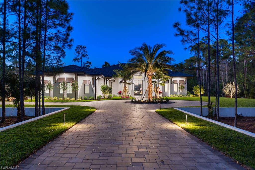 Just completed custom estate set on an expansive approx. 0.69-acre homesite within the gated enclave of Naples Club Estates, directly adjacent to Naples National Golf Course. Preserved views and exceptional privacy offer estate-level scale rarely found this close to Naples’ beaches and downtown. The thoughtfully designed single-story residence offers  nearly 9,700 sq ft of total living space, featuring 5 bedrooms arranged in a well-defined layout that balances openness with privacy. Interiors are finished with wide-plank Legno Bastone European French Oak flooring, soaring ceilings with custom beam detailing, refined millwork, and a cohesive designer palette throughout. Living spaces are thoughtfully delineated rather than fully open, creating a sense of architectural structure while maintaining seamless flow to the outdoor areas. The designer kitchen is a standout, featuring custom wood cabinetry with reeded detailing, glass-front display uppers, and integrated lighting. A waterfall Perla Venata quartzite island and matching countertops,, anchor the space and pair beautifully with a walk-through pantry for optimal function. The professional appliance suite includes Sub-Zero refrigeration and wine storage, Wolf induction cooking and wall ovens.. A built-in wet bar with stone surfaces, beverage refrigeration, and wine storage enhances entertaining while maintaining a tailored, architectural aesthetic.The primary suite is a serene retreat with tranquil preserve views and direct lanai access. Architectural wall detailing, layered lighting, and generous proportions create a calm, refined atmosphere. The spa-inspired primary bath features a freestanding soaking tub, oversized glass-enclosed shower with dual rain heads and hand shower, large-format stone and porcelain tile, custom dual vanities with stone countertops, & custom closets. Additional en-suite bedrooms are generously sized, each offering private baths finished with custom cabinetry, stone surfaces, & curated tile selections. providing comfort and privacy for family and guests. Outdoor living is a true resort-style experience, with a large screen-enclosed pool and spa featuring illuminated water elements and a dramatic linear fire feature. The covered lanai includes a fireplace, fully equipped outdoor kitchen, dedicated bar area, pool bath, and outdoor shower, with multiple lounge zones for dining, entertaining, and relaxation surrounded by tranquil preserve. Built by Forge Construction to increadible standards, the home includes impact-rated windows and doors, smart-home integration, dual-zone HVAC with dehumidification, tankless gas water heaters, a whole-house generator prep, and premium materials throughout. Naples Club Estates is prized for gated privacy, estate-sized homesites, and preserved natural surroundings, offering a rare blend of exclusivity and convenience in one of Naples’ most discreet luxury communities.