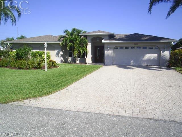 Beautiful home in SE Cape Coral with direct access & no bridge to the river. Spacious 3 BR and 2 BA 2 car garage. Large master bdrm with walk in closet & the master bath is spacious with granite counters 2 sinks. Large shower with glass doors a must see! Screened in solar heated salt water pool with beautiful rock waterfall. If you enjoy cooking and entertaining inside or out this is the home for you. The kitchen inside has been upgraded with granite and stainless appliances with a pass through to the Lanai. Guest rooms have recently been upgraded with tile floors. Enjoy entertaining on the patio with the outdoor gas grill & kitchen area. Great size dock with tiki hut on the water. For the boaters 2 lifts for your boat(s) one is a 16,000LB plus a lift for your jet ski! This home is a straight shot to the river.