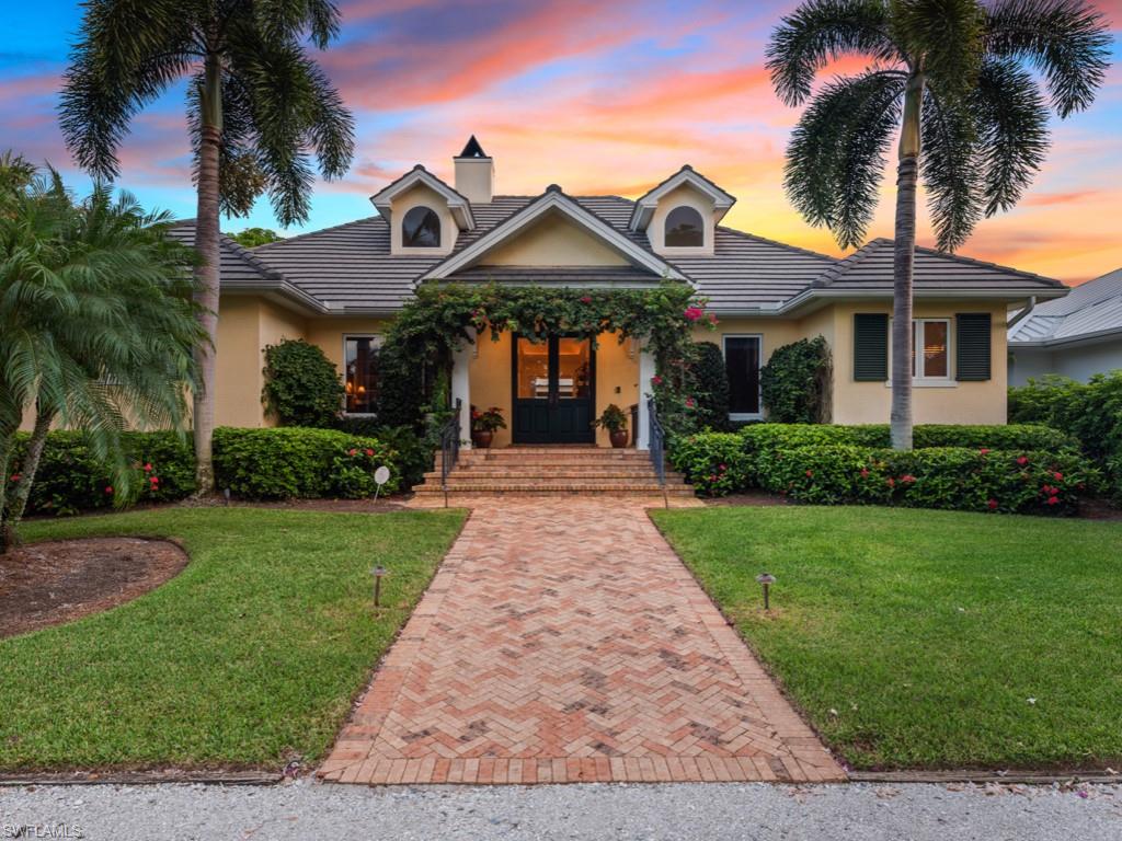 A stunning custom-built showpiece by Frontier Homes, located steps to white sand beaches in the heart of Olde Naples, this extraordinary residence was thoughtfully designed with a spectacular layout that wraps around an expansive outdoor living area perfect for entertaining. Luxurious details and finishes abound throughout the home including an updated kitchen, custom built-in eating area, a gas fireplace, exotic black walnut flooring, intricate millwork, and more! The oversized master suite with a spa-like bath is situated on the main floor, along with a separate study and guest suite. Upstairs is another spacious suite with a bath. Multiple sets of French doors in the family room, master, and guest suite open out to an inviting courtyard-like veranda with covered seating, sparkling pool, spa, and sun patio. A two and a half car garage with a hard-wired Tesla charger is situated to the rear of the property offering convenient alley access with additional parking in the front. With an ideal location walking distance to beaches and a plethora of fine shopping and dining venues, this custom residence offers all the elements one needs to live a lavish Olde Naples lifestyle!