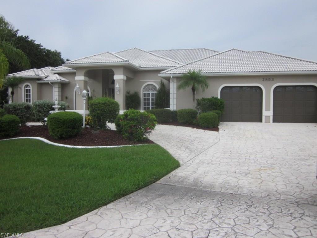 This is a stunning home on a huge lot with lots of privacy & magnificent view.  Over 3800 SF on the Spreader Canal. Recently updated with granite counters.  Wonderful outdoor Summer kitchen with granite counter tops, & paver pool deck.  Giant master suite with an attached exercise room.  Large  laundry with new cabinets & counters. Huge pool area with over resort style pool  Over 180' of water frontage overlooking the mangroves.  10,000# boat lift with separate jet ski lift. Exterior of home just repainted.