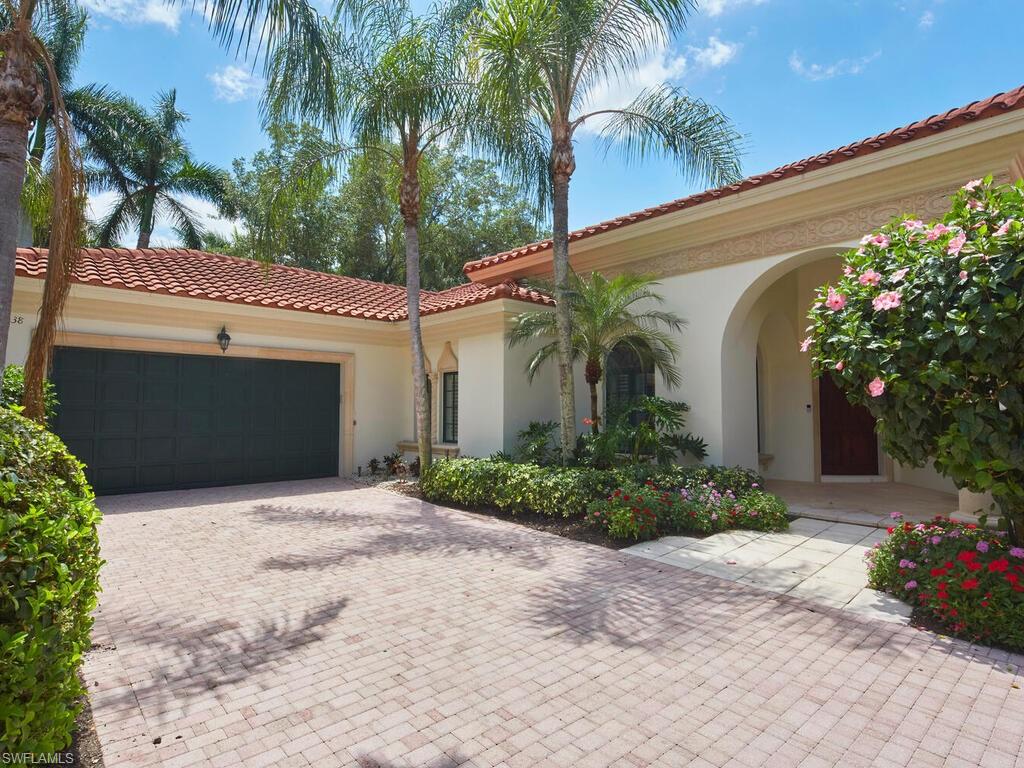 Grey Oaks Perfection! This beautifully reimagined, and professionally decorated three-bedroom plus den home is ready for you to move right in. An inviting, vast and open floor plan transitions seamlessly to an outdoor oasis of tropical landscaping surrounding your private pool. And, this is all made better with a southwestern facing lot.  The home's great room concept, with its expansive ceilings, is ideal for entertaining, with plenty of space for privacy when needed. Completely redone with new flooring, a chef’s kitchen with high-end appliances, built-in cabinetry, a full laundry room and butler’s pantry, and so much more. The oversized primary suite features a sitting area with views of the pool, a large master bathroom with dual sinks and vanities, and sizable shower. Two en-suite guest bedrooms, and an office finish this spectacular home. Additional features include synthetic grass off the pool, upgraded exterior lighting, a tankless water heater, a new HVAC system, and a new pool heater. Grey Oaks Country Club boasts three golf courses, and a fantastic community lifestyle and amenities such as the wellness center, a spa, a resort-style pool, tennis, pickleball, bocce, fine dining, and much more. This private home is situated in close proximity to the Club. Grey Oaks is a short drive to downtown Naples, shopping, gourmet dining, and pristine white-sand beaches. A "turn-key" gem waiting for you to begin enjoying.